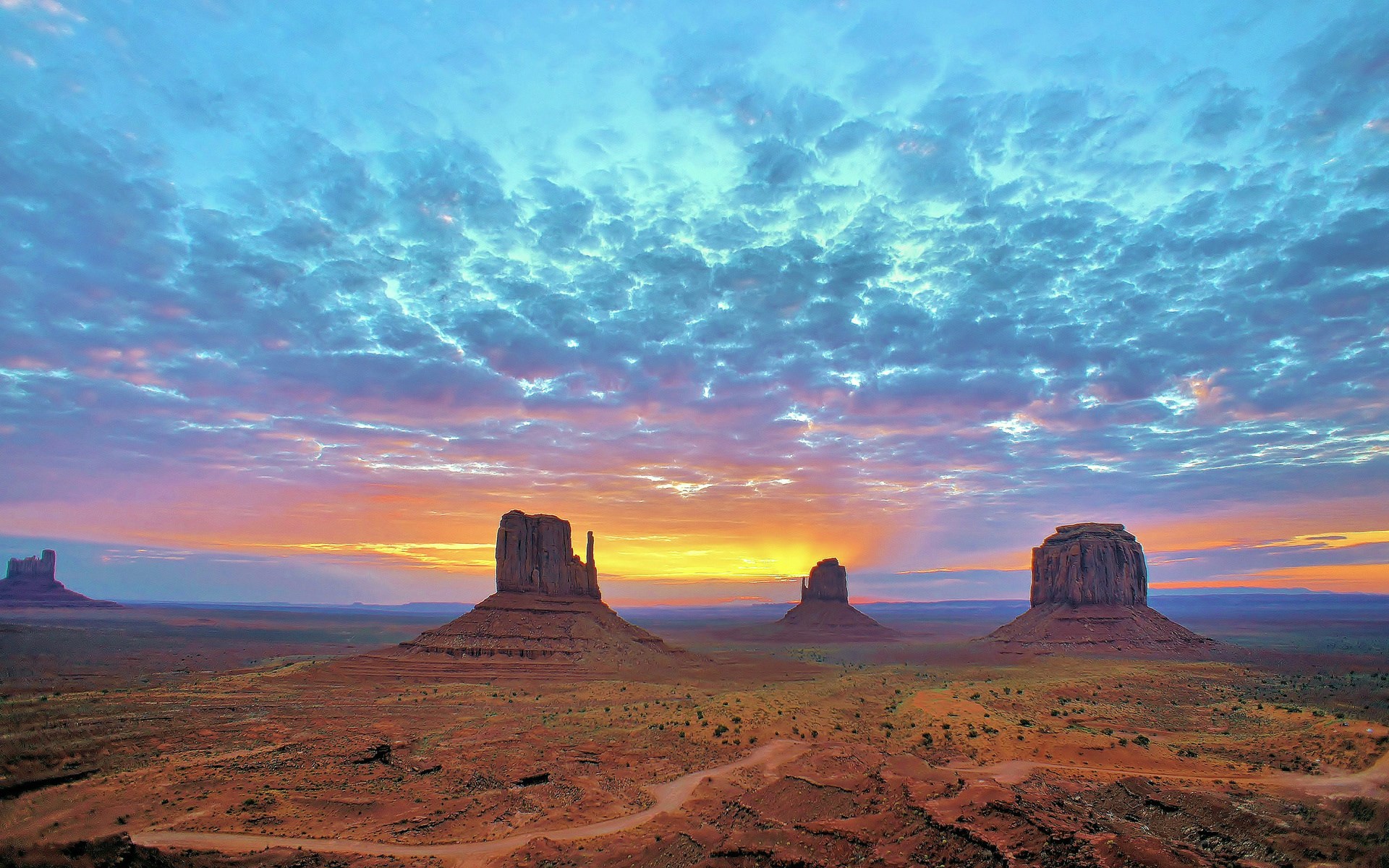 Monument Valley at sunrise with colorful clouds HD Wallpaper