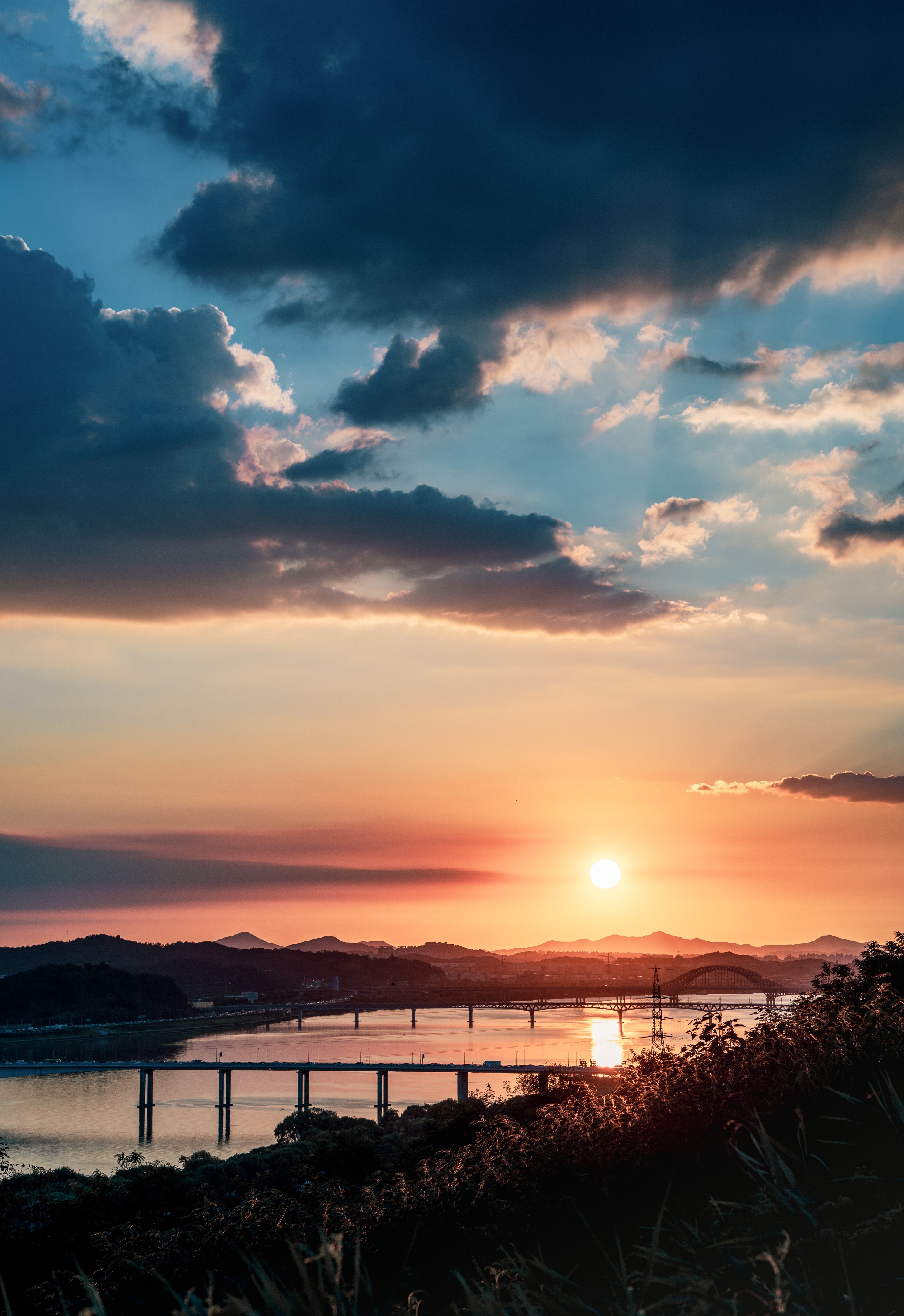 Sunset over a river with bridges and hills HD Phone Wallpaper