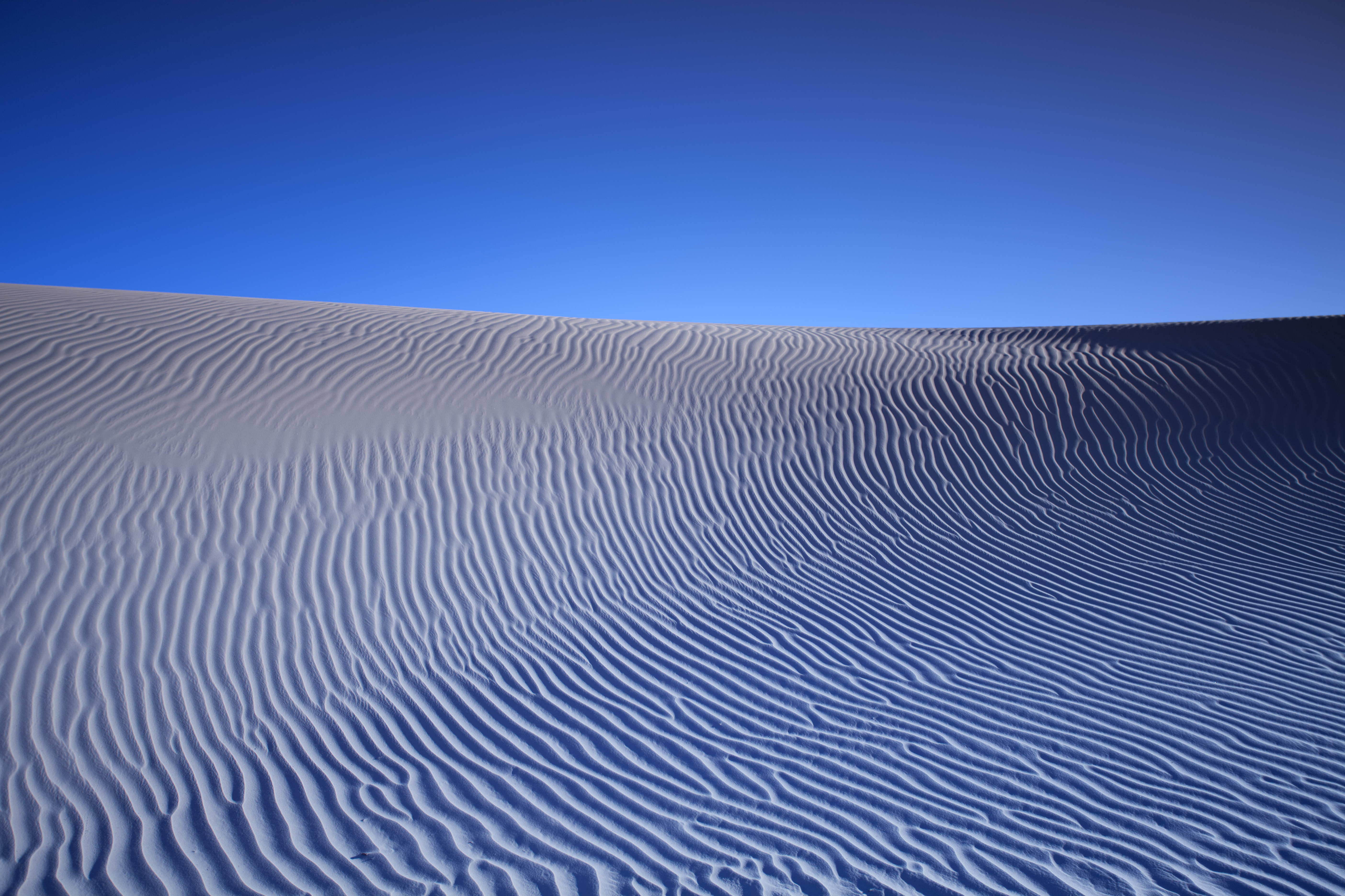 Sand dunes under a clear blue sky HD Wallpaper