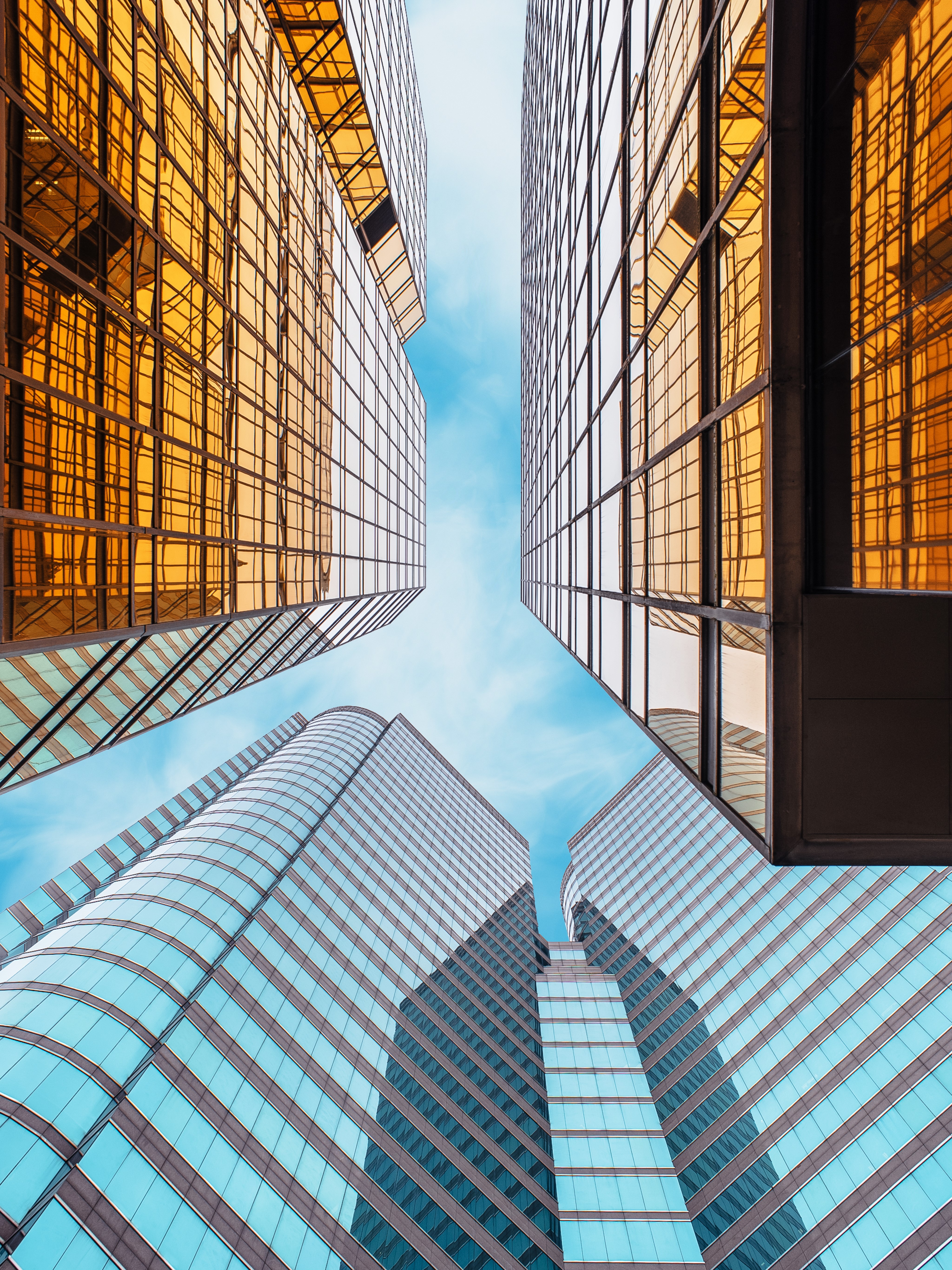 Looking up at skyscrapers with mirrored glass facades HD Phone Wallpaper