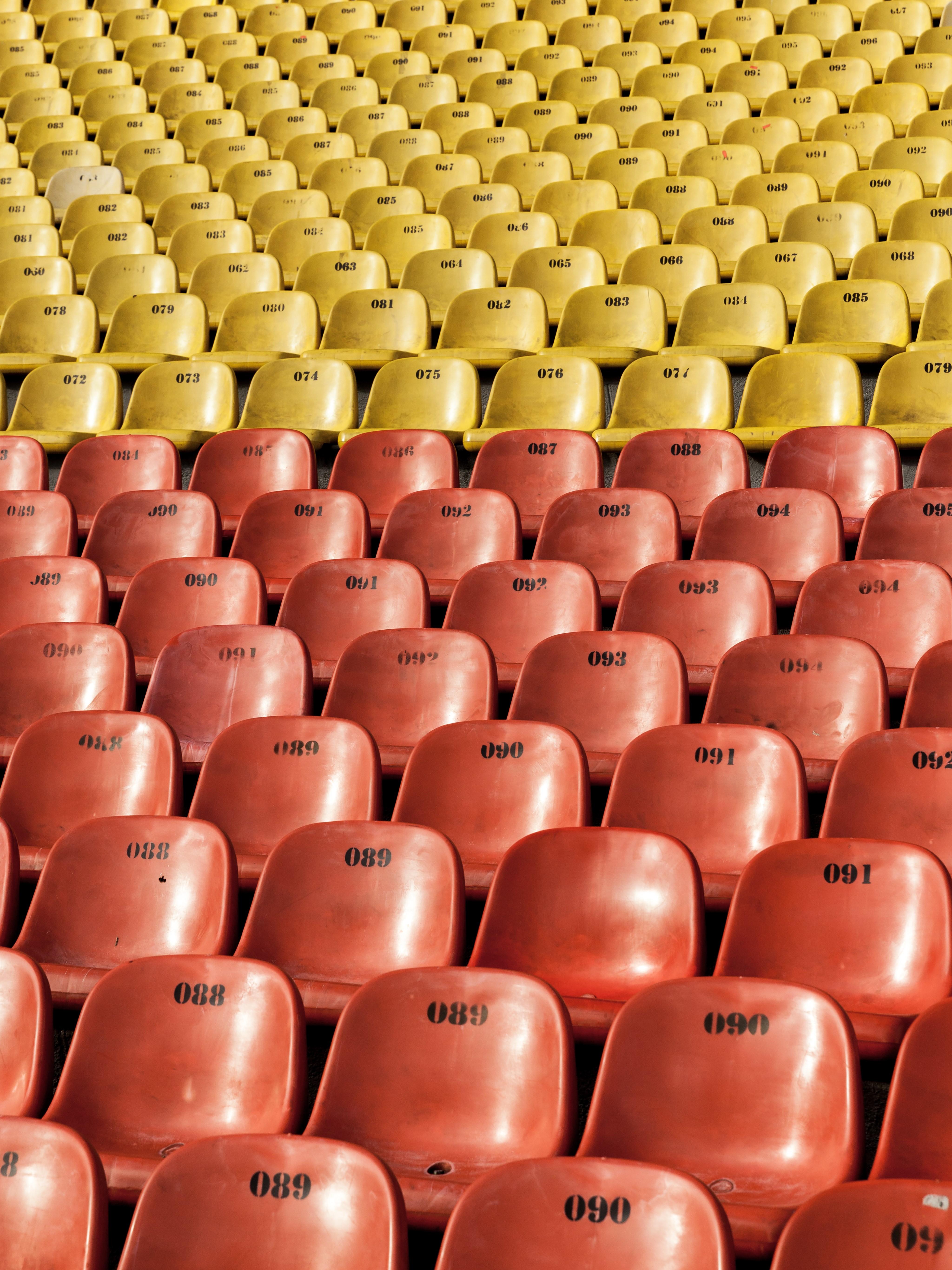 Rows of yellow and red stadium seats HD Phone Wallpaper