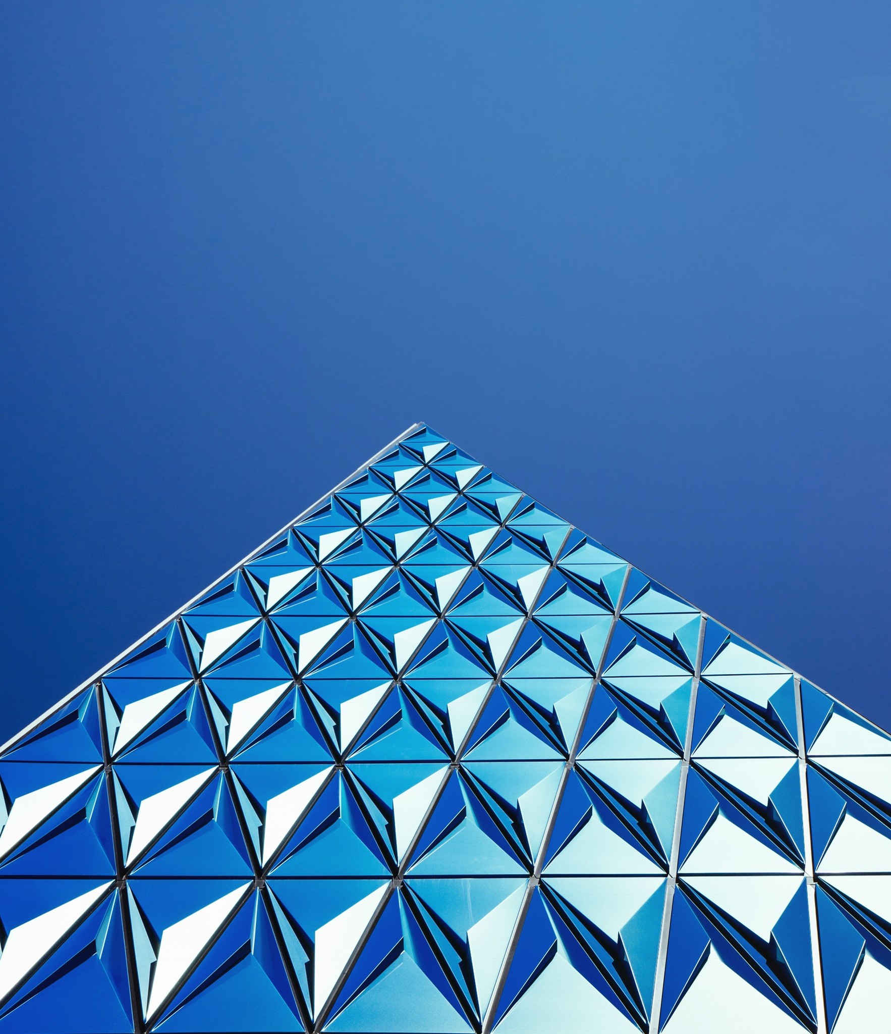 Modern building with geometric facade against clear blue sky HD Phone Wallpaper