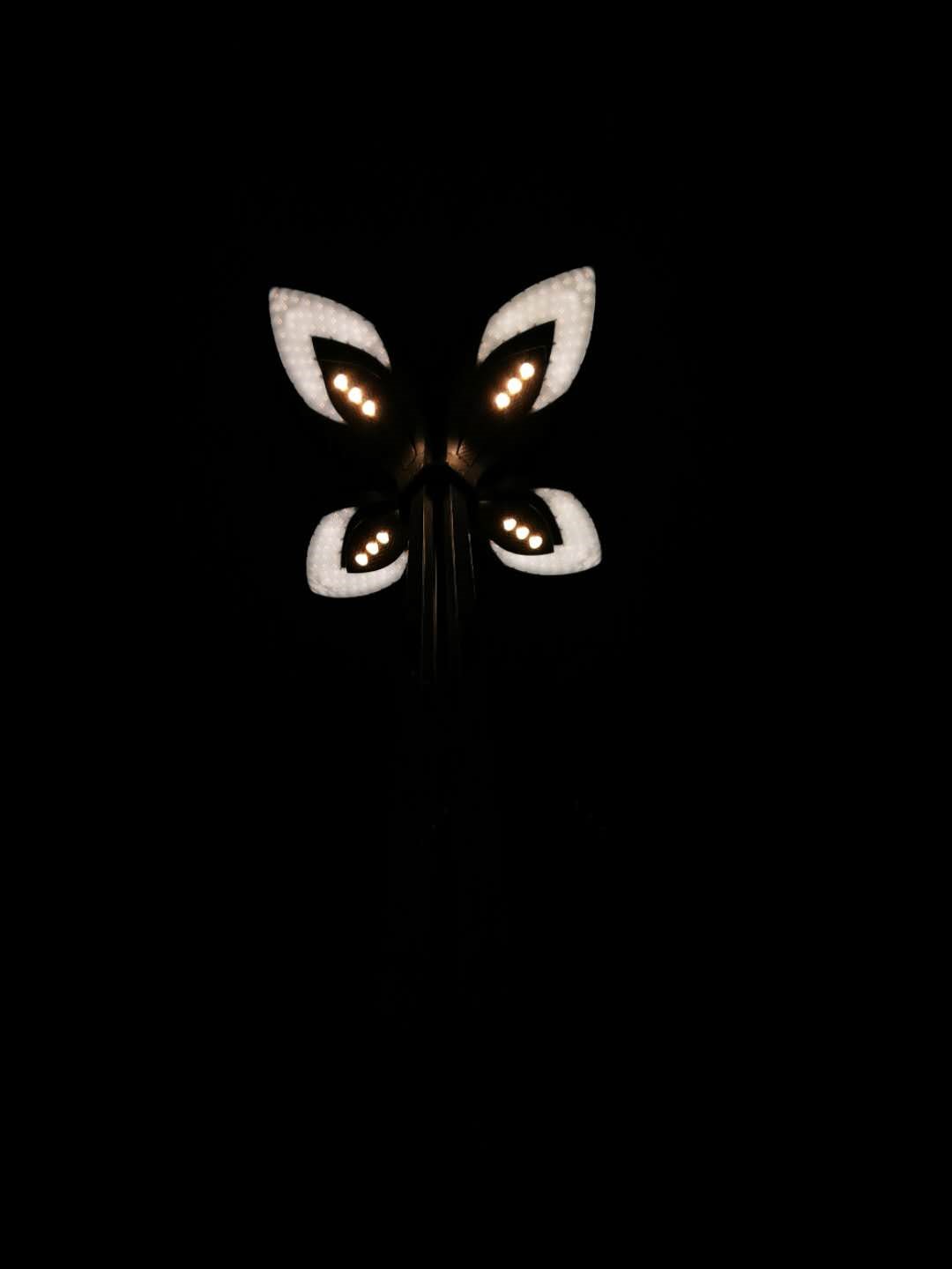 Butterfly-shaped street light at night HD Phone Wallpaper