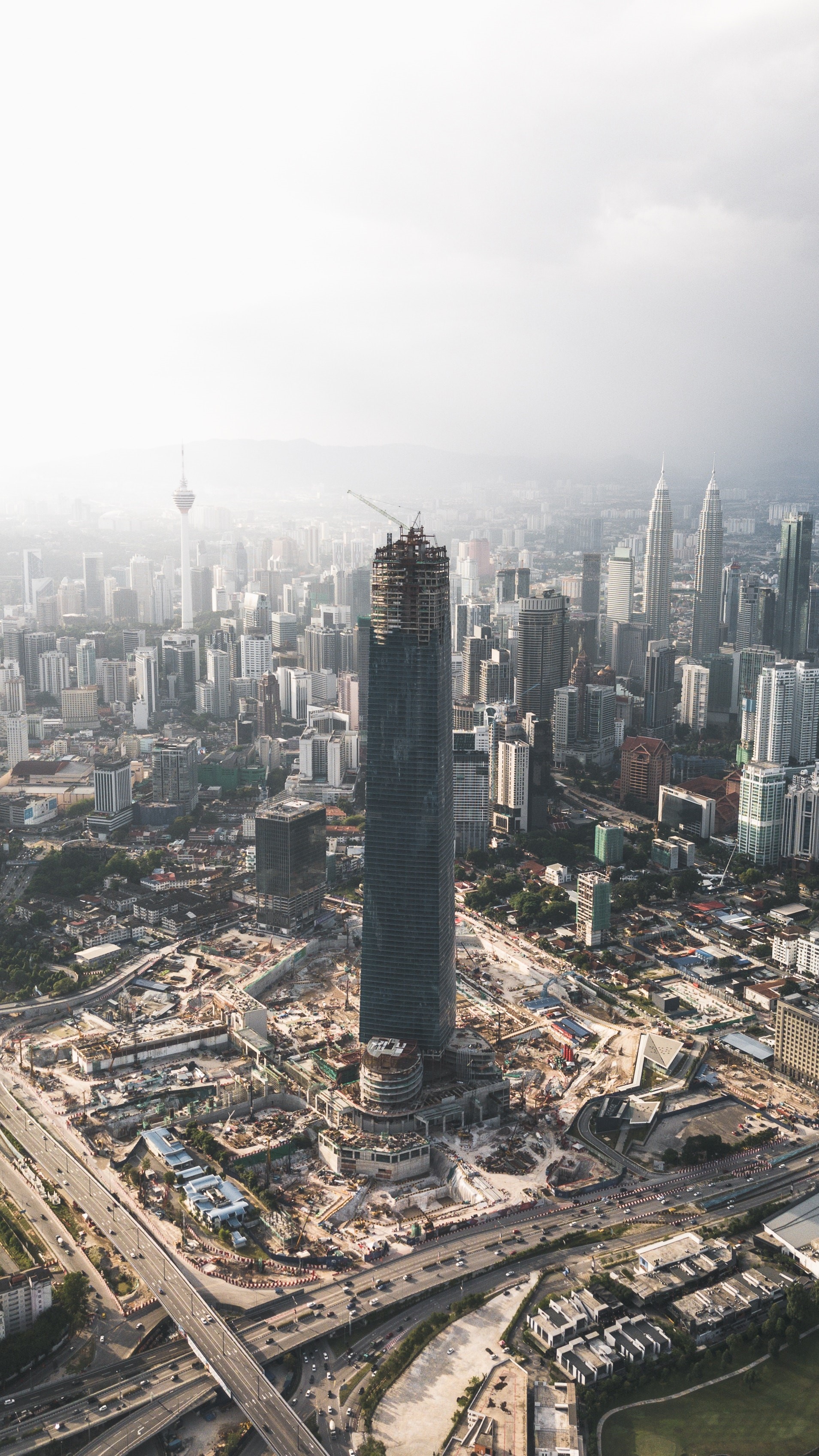 Aerial view of Kuala Lumpur construction site with skyscrapers HD Phone Wallpaper