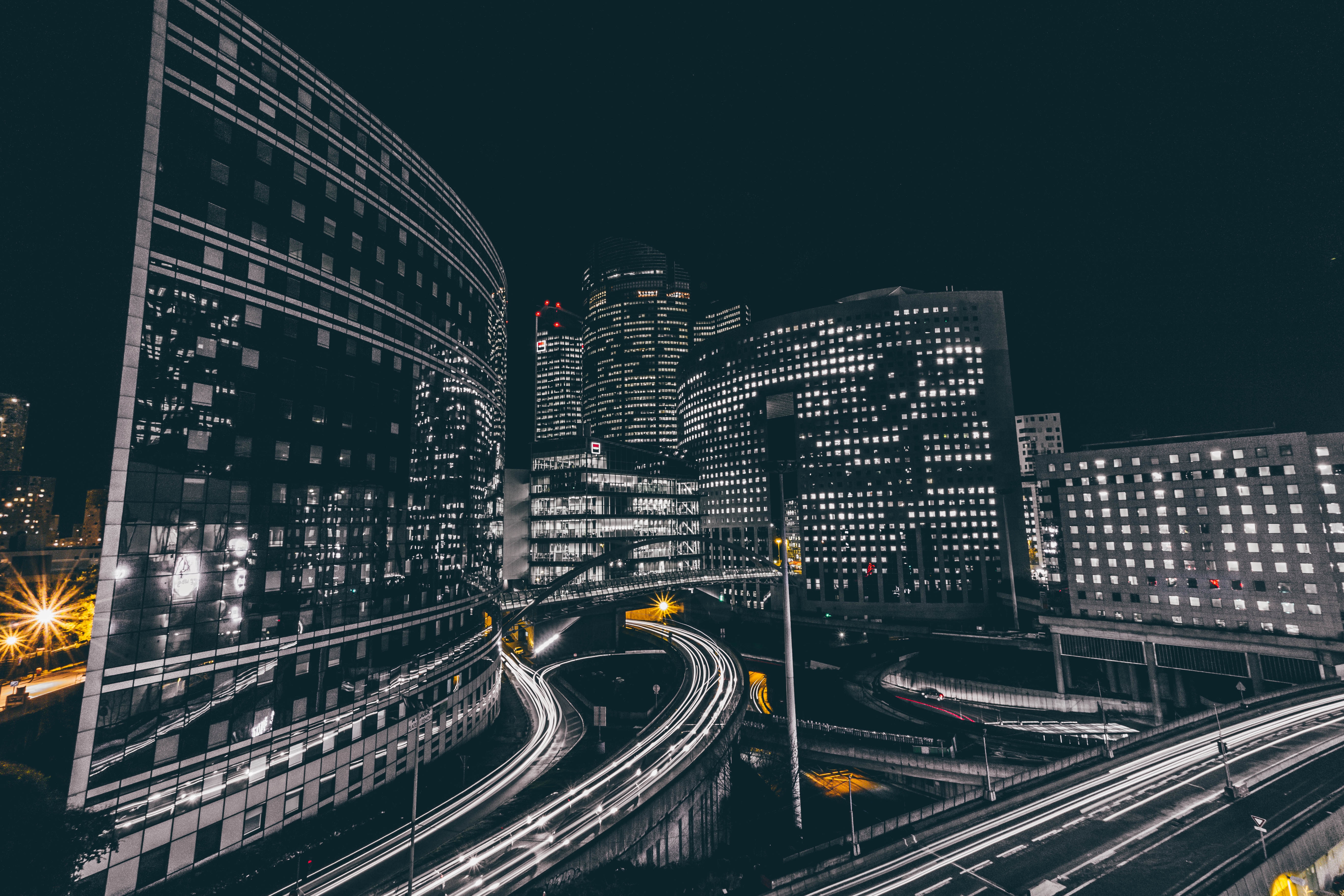 Night cityscape with light trails in La Défense, Paris HD Wallpaper