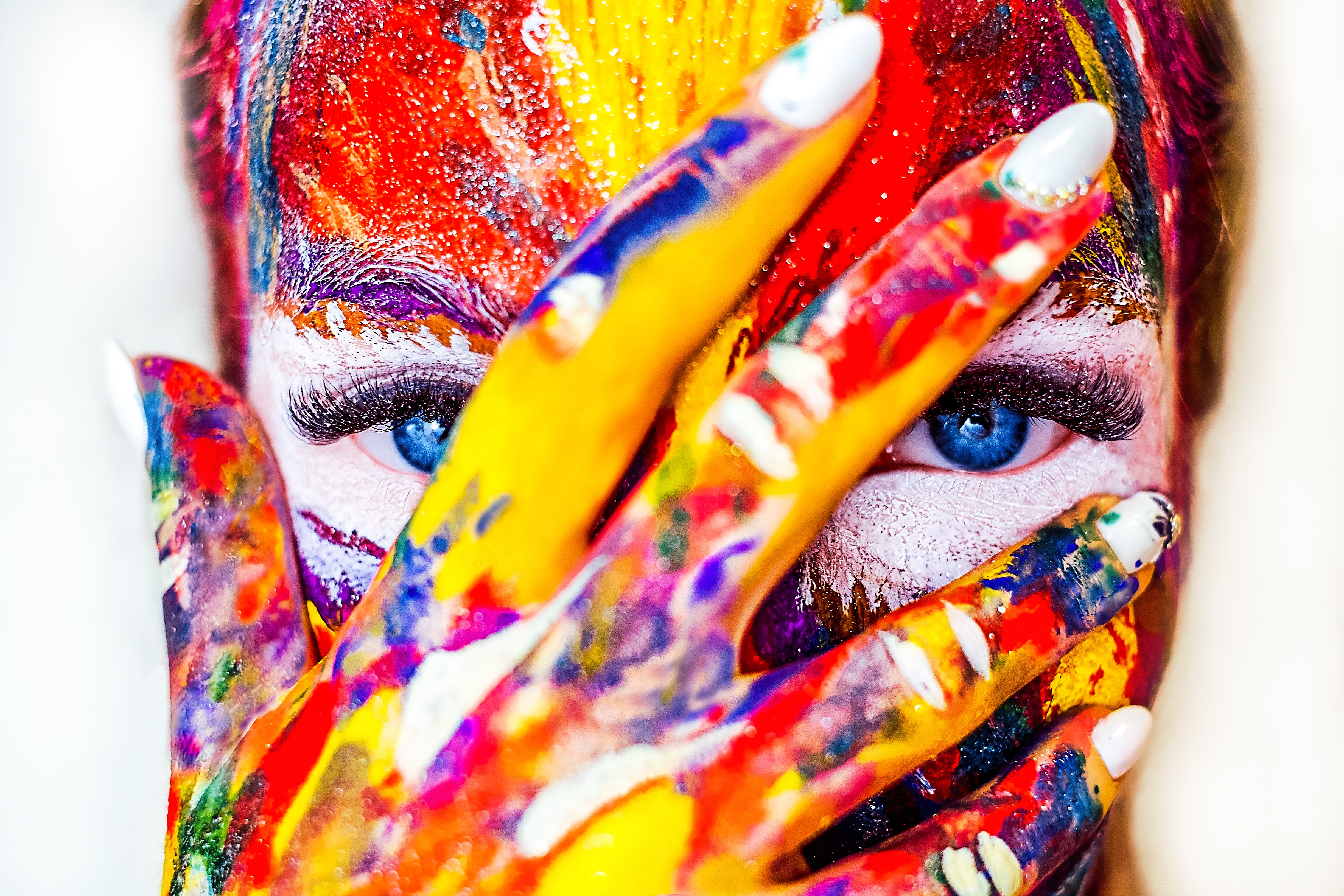 Woman with colorful paint on face and hand HD Wallpaper