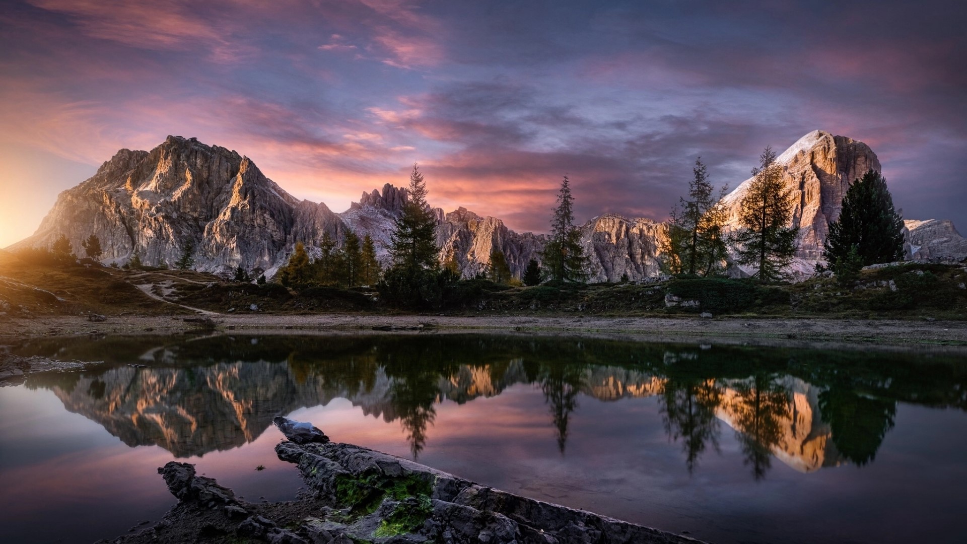 Mountain range reflected in a lake at sunset HD Wallpaper