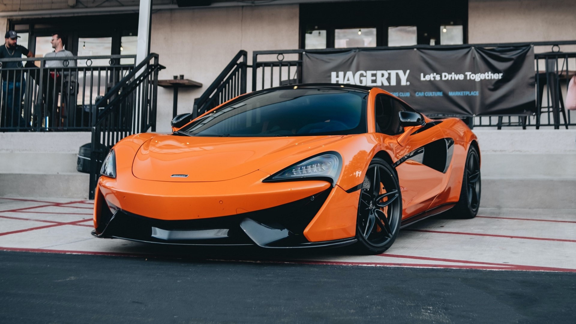 Orange McLaren 600LT parked outside Hagerty HD Wallpaper