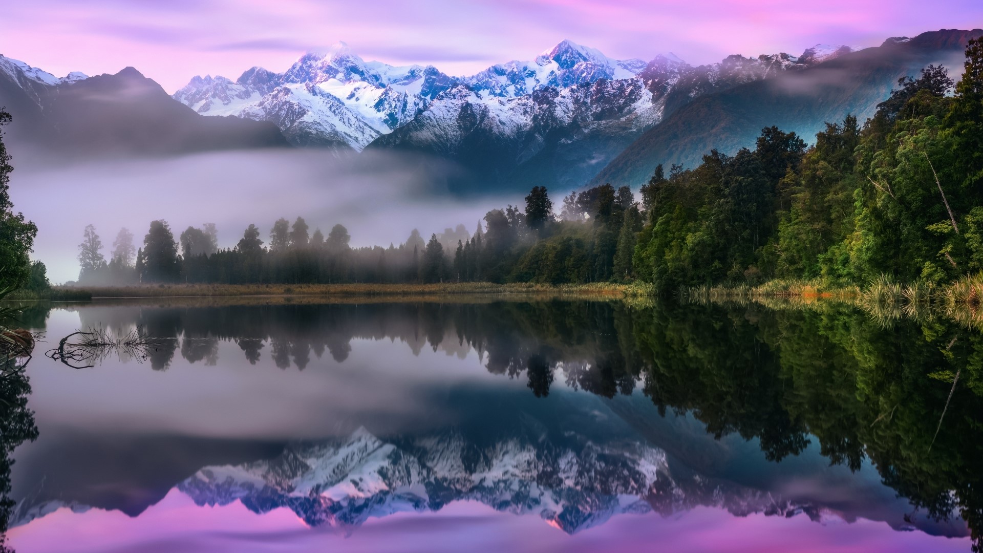 Snow-capped mountains reflected in a lake with forest HD Wallpaper
