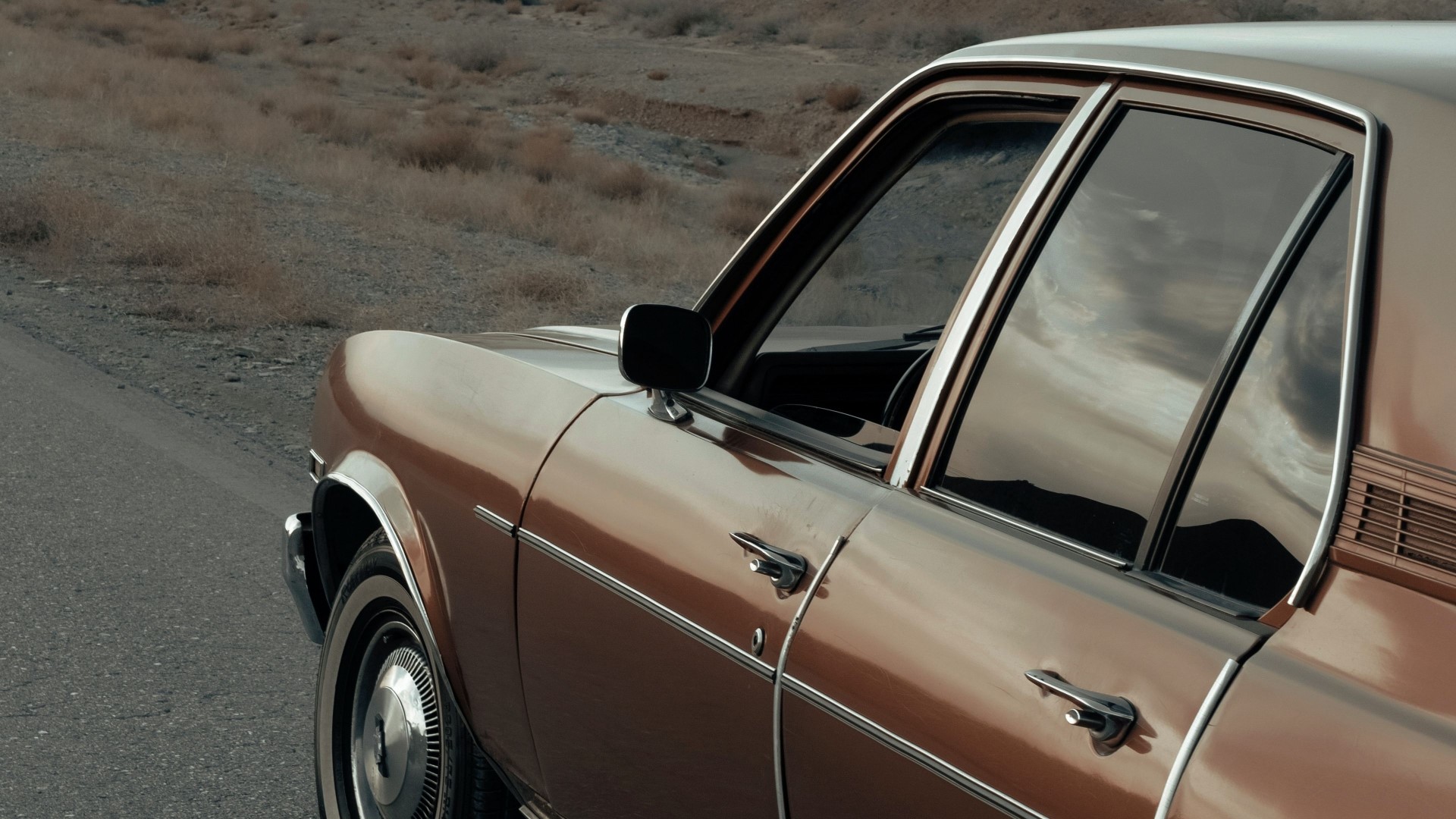 Retro brown car on a desolate road HD Wallpaper