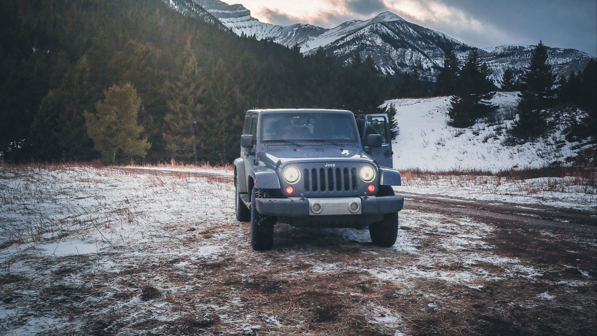 Blue Jeep parked in snowy mountain landscape HD Wallpaper