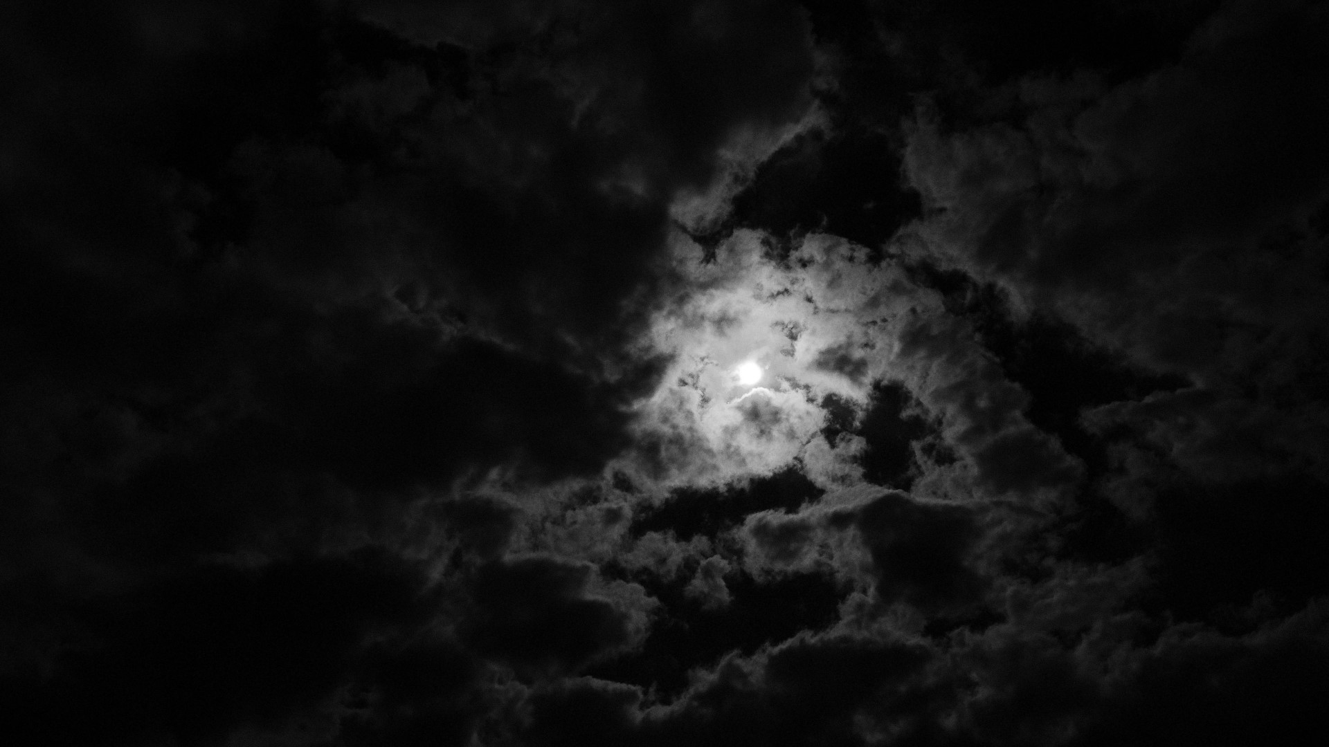 Moon behind dark clouds HD Wallpaper