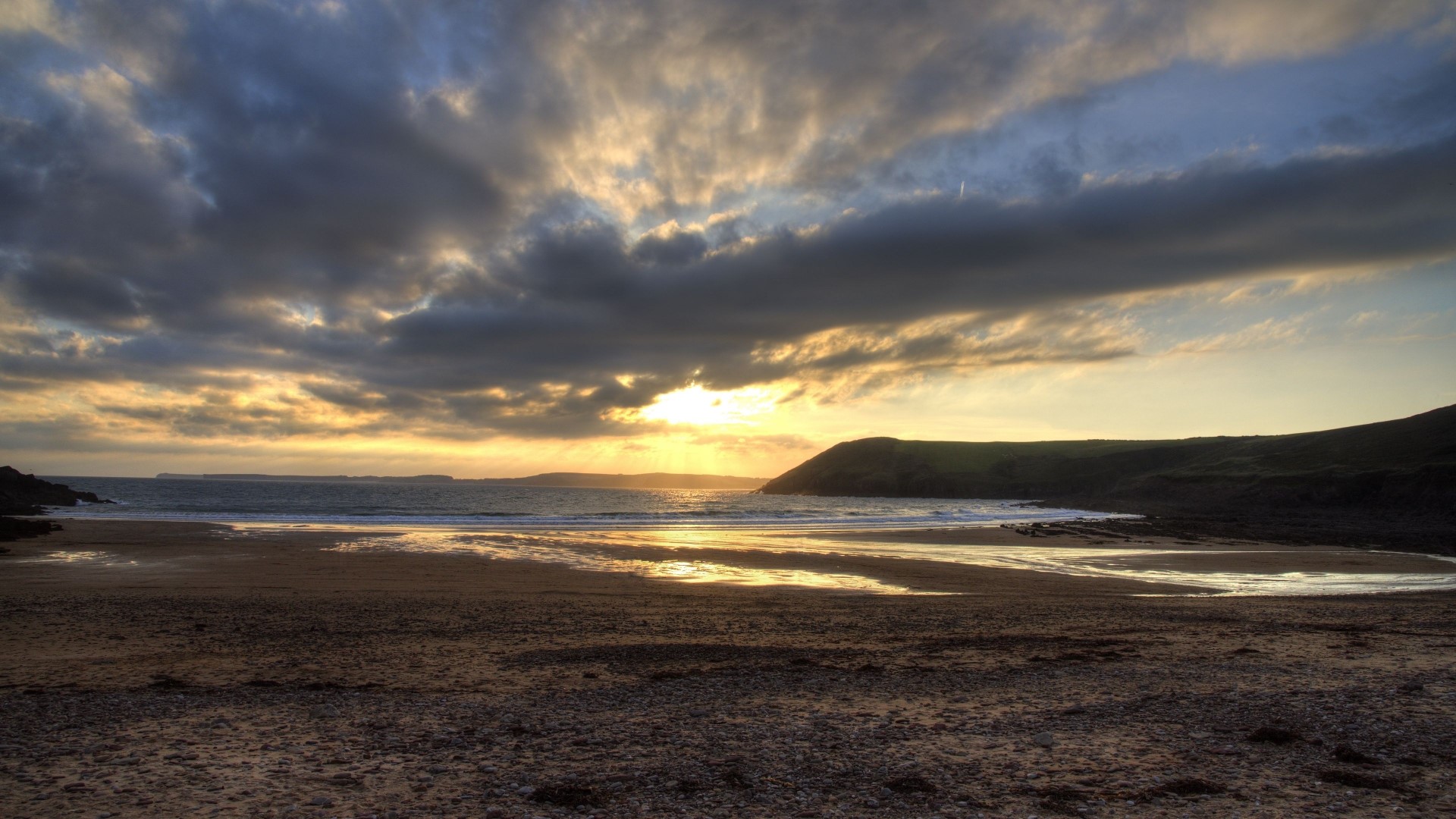 Sunset over a beach with dramatic clouds HD Wallpaper