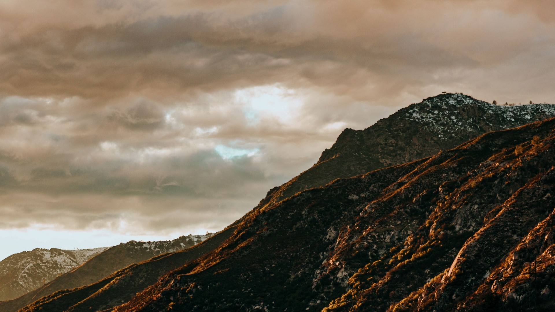 Mountain range with dramatic clouds at sunset HD Wallpaper