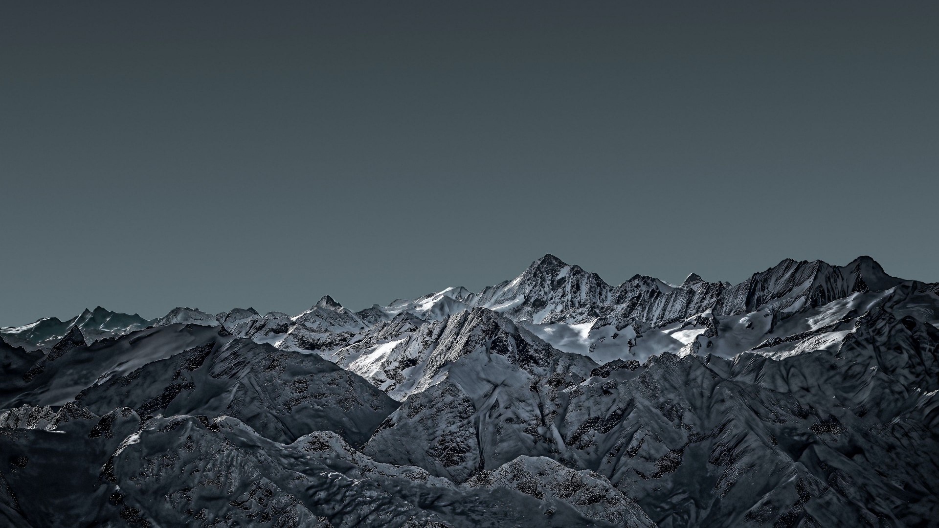 Snow-capped mountain range under a dark sky HD Wallpaper