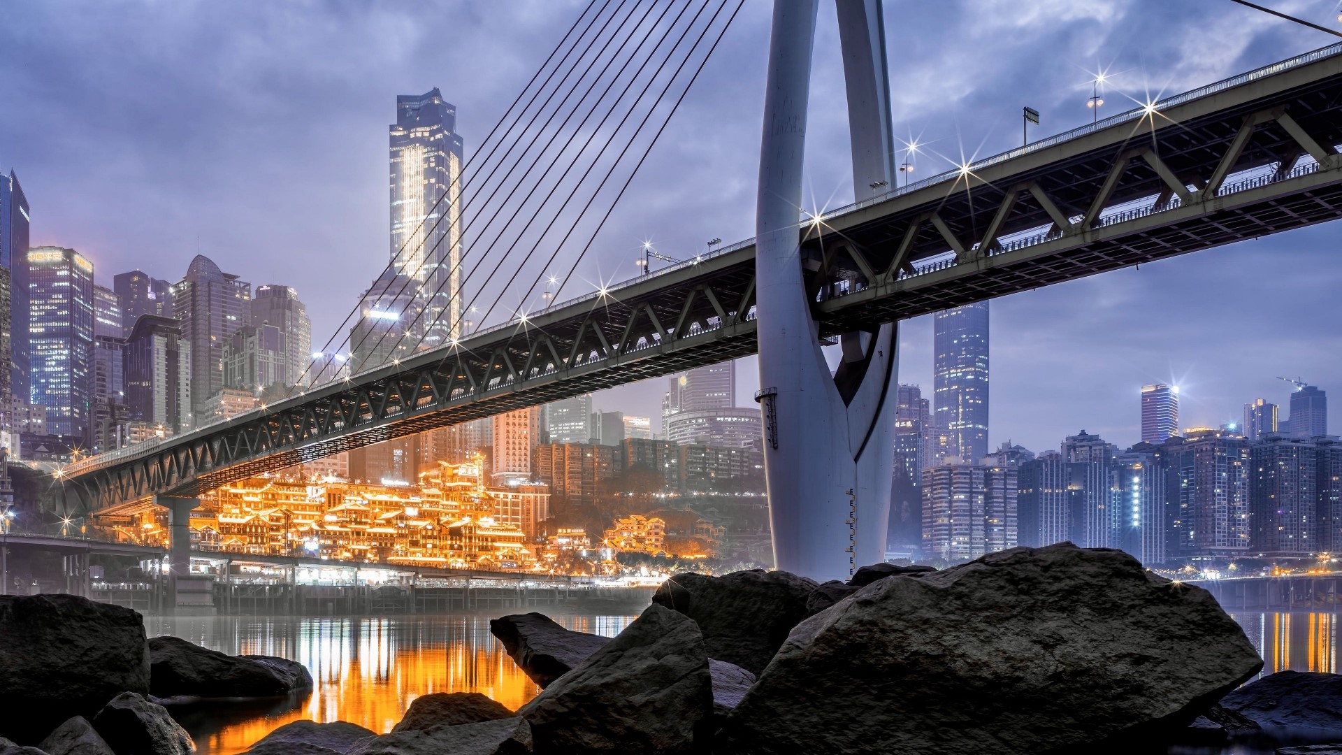 Bridge over river in a city at night HD Wallpaper