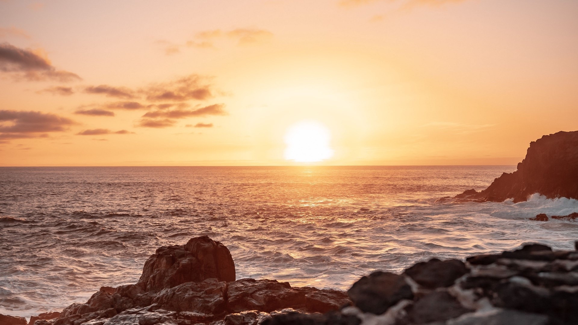 Sunset over the ocean with rocky shore HD Wallpaper
