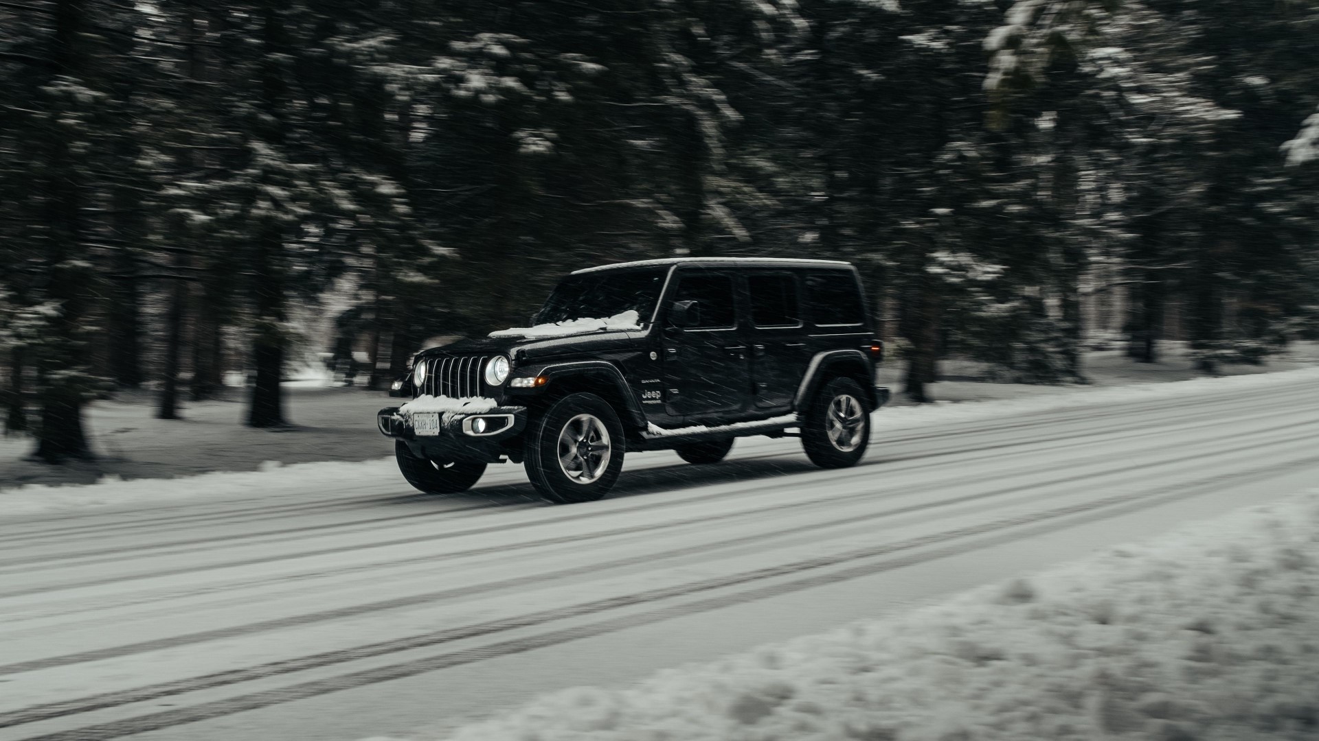 Black Jeep Wrangler driving on a snowy road HD Wallpaper