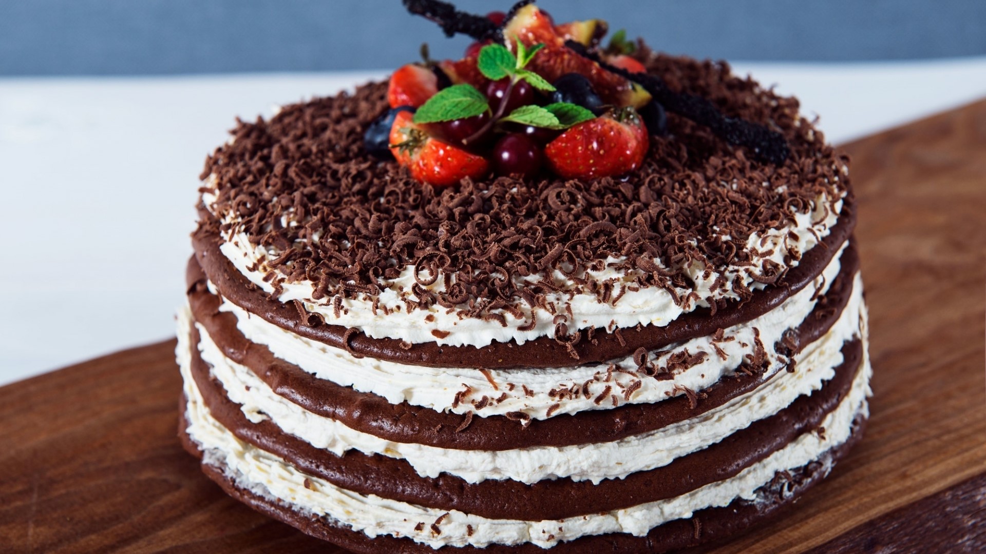 Chocolate layer cake with whipped cream and berries HD Wallpaper