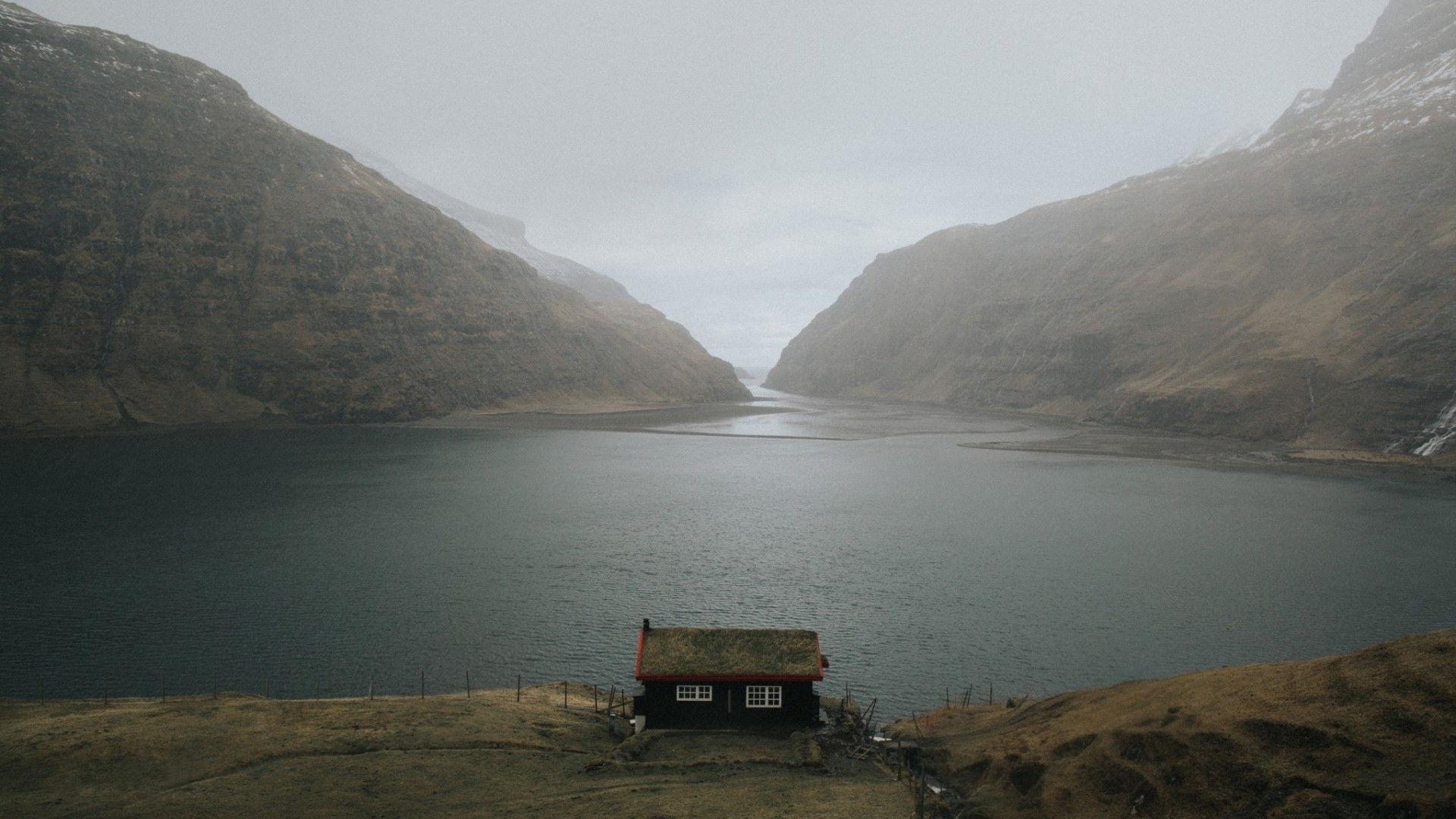 Small house by a fjord with mountains HD Wallpaper