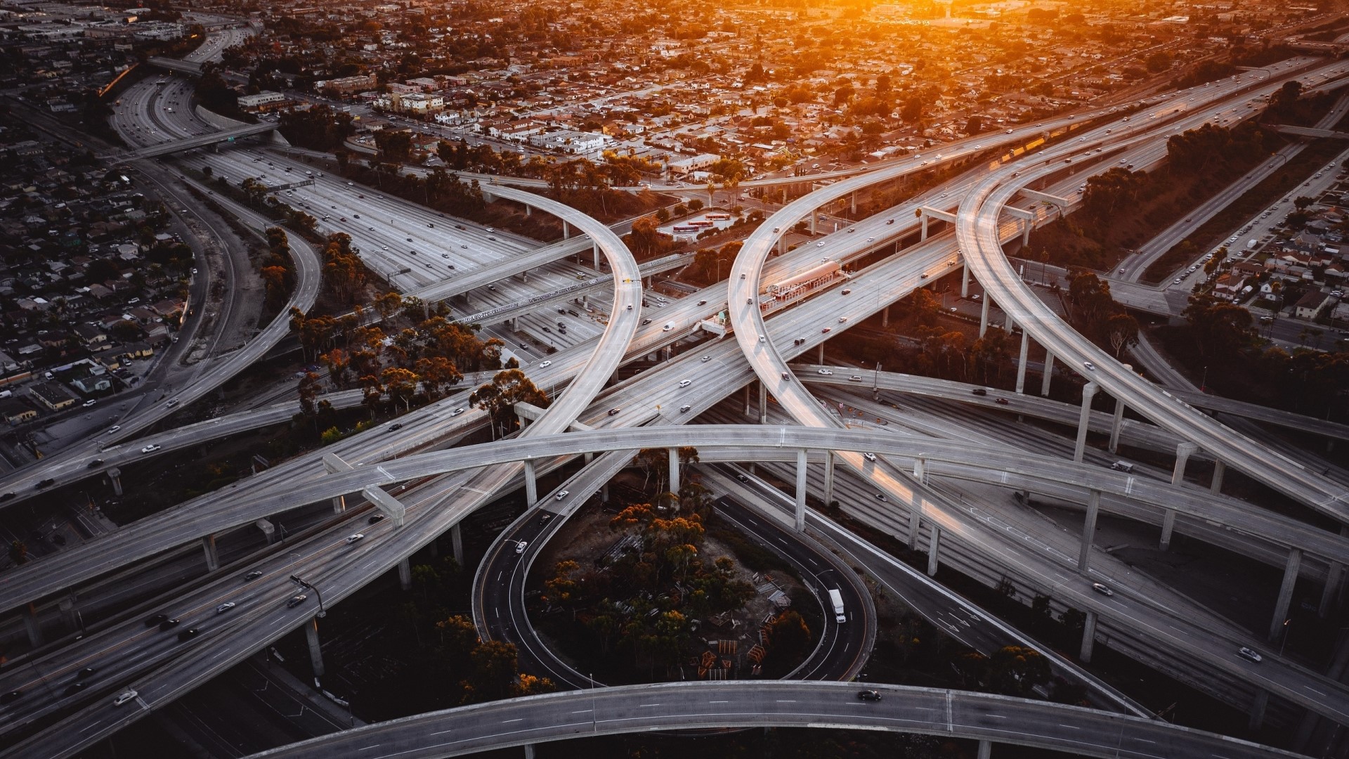 Aerial view of Los Angeles freeway interchange at sunset HD Wallpaper