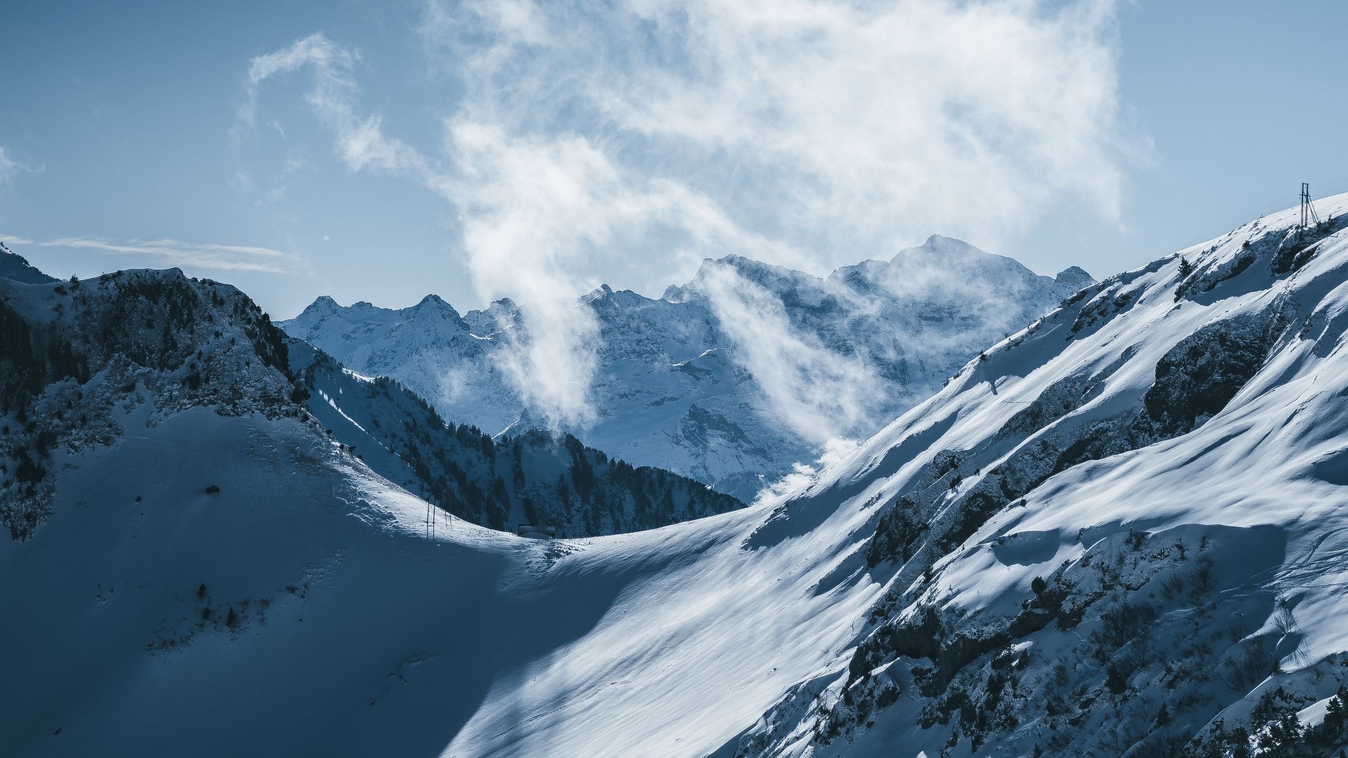 Snowy mountains with wind blowing snow HD Wallpaper