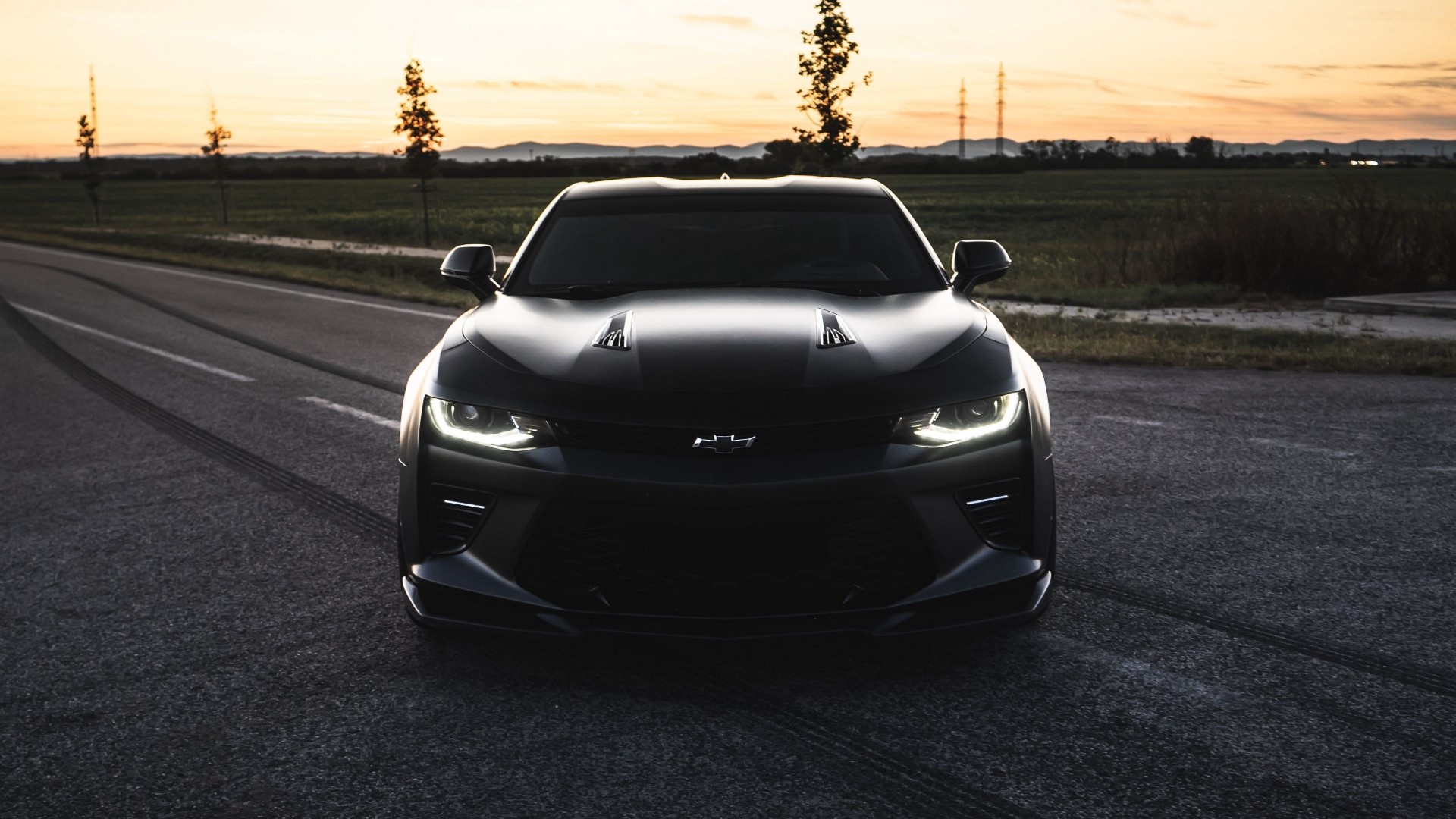 Black Chevrolet Camaro on a road at sunset HD Wallpaper