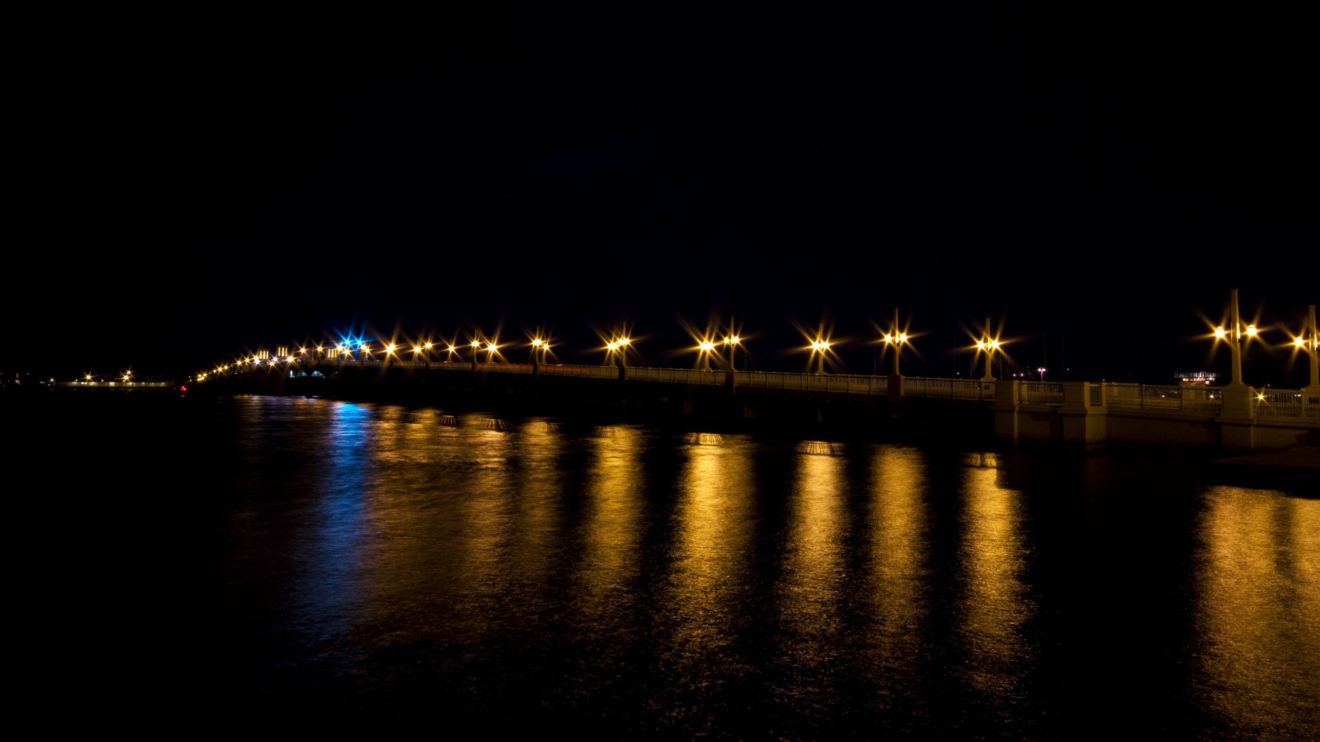 Bridge with lights at night over water HD Wallpaper