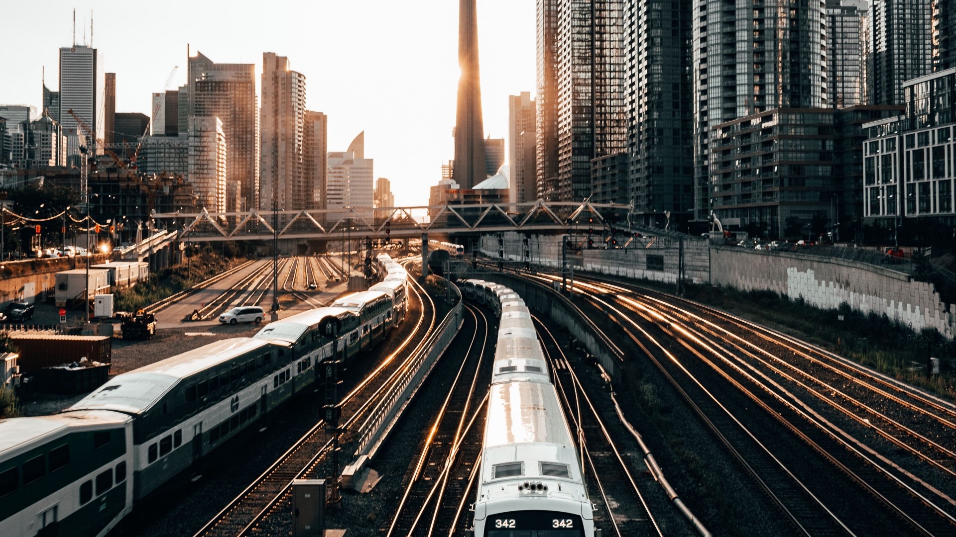 Trains on tracks in a city with skyscrapers HD Wallpaper