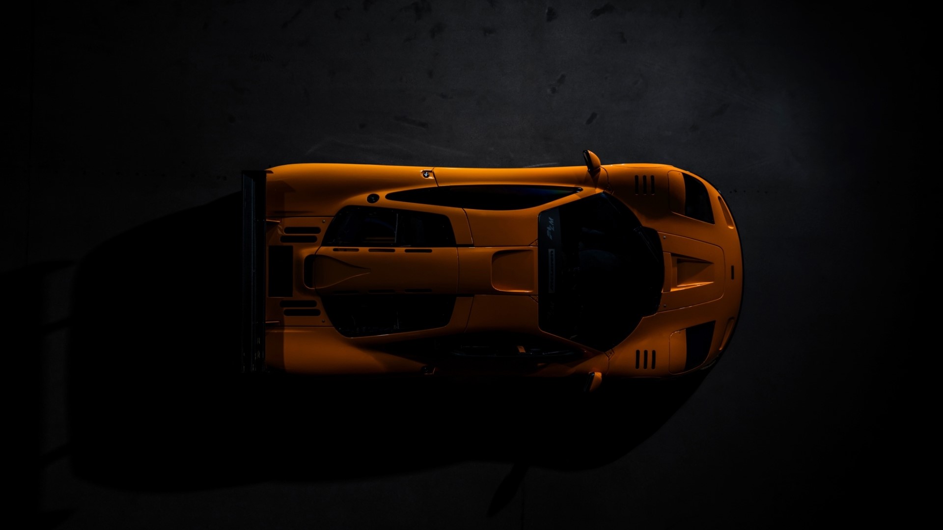 Orange McLaren race car from above HD Wallpaper