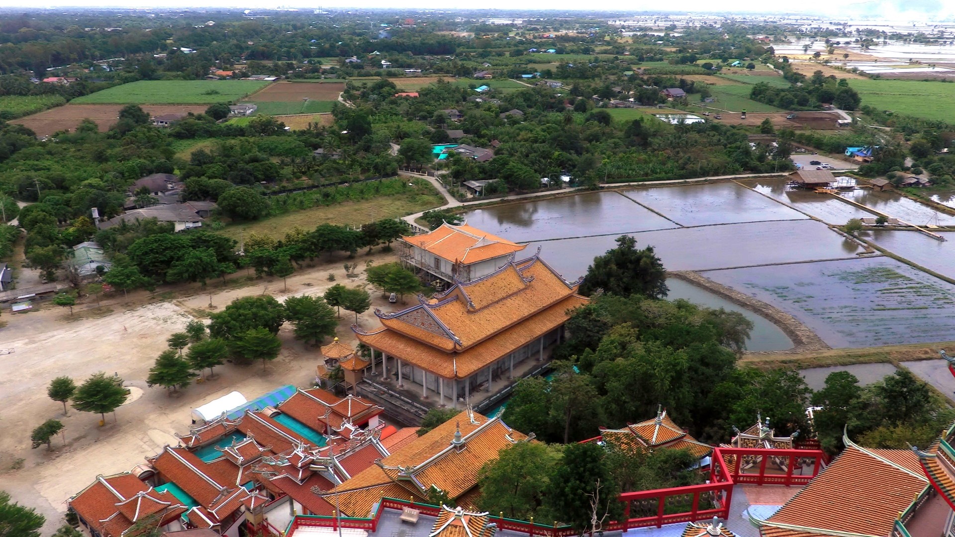 Aerial view of Wat Tham Suea temple and rice paddies in Thailand HD Wallpaper