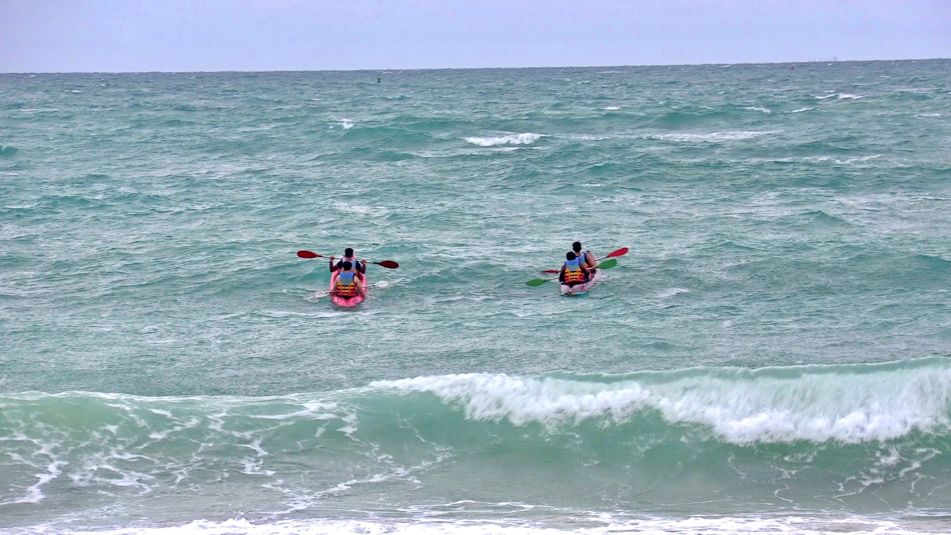 Two kayaks with people paddling in the ocean HD Wallpaper