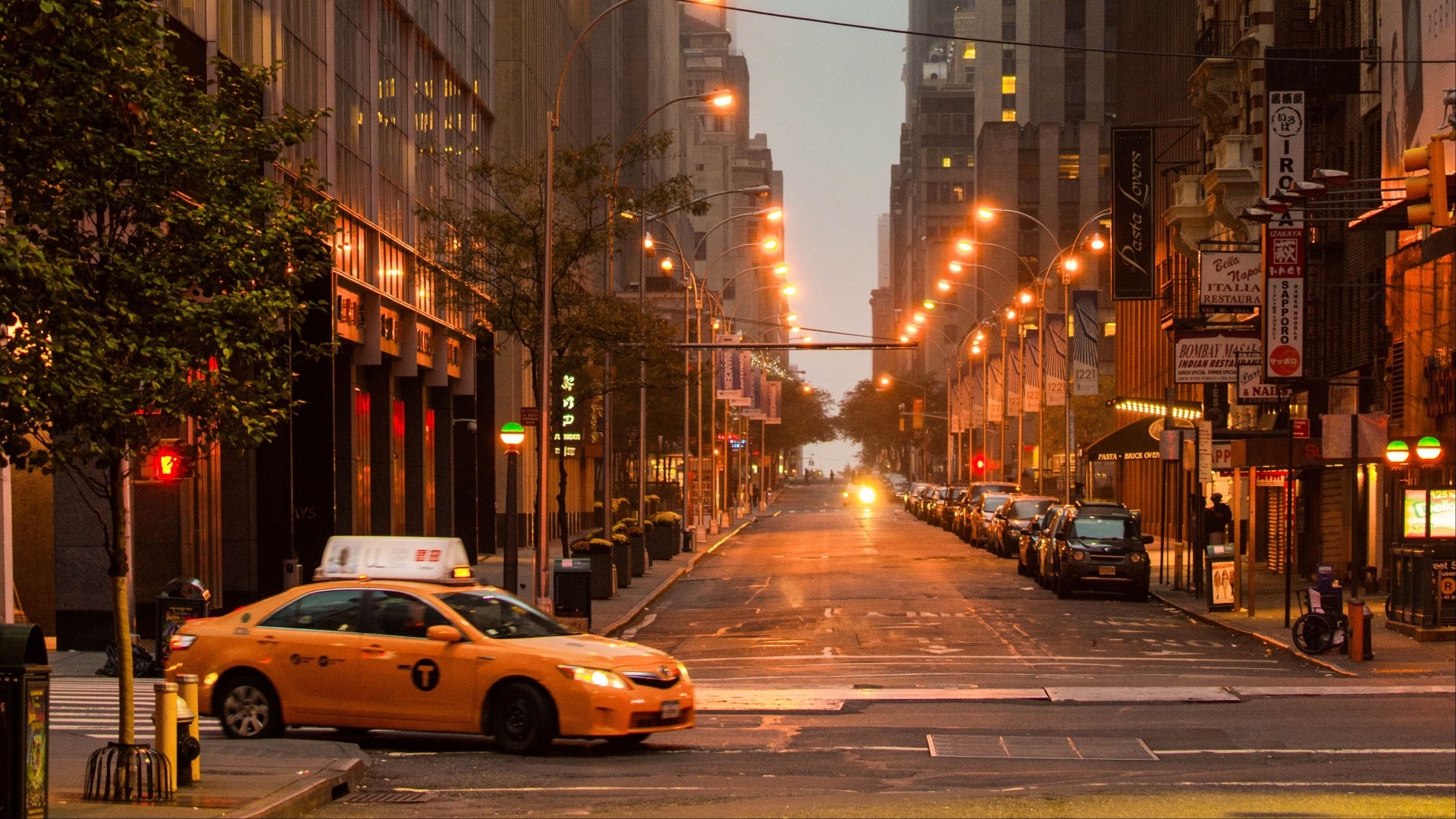 Yellow taxi on a New York City street at dusk HD Wallpaper