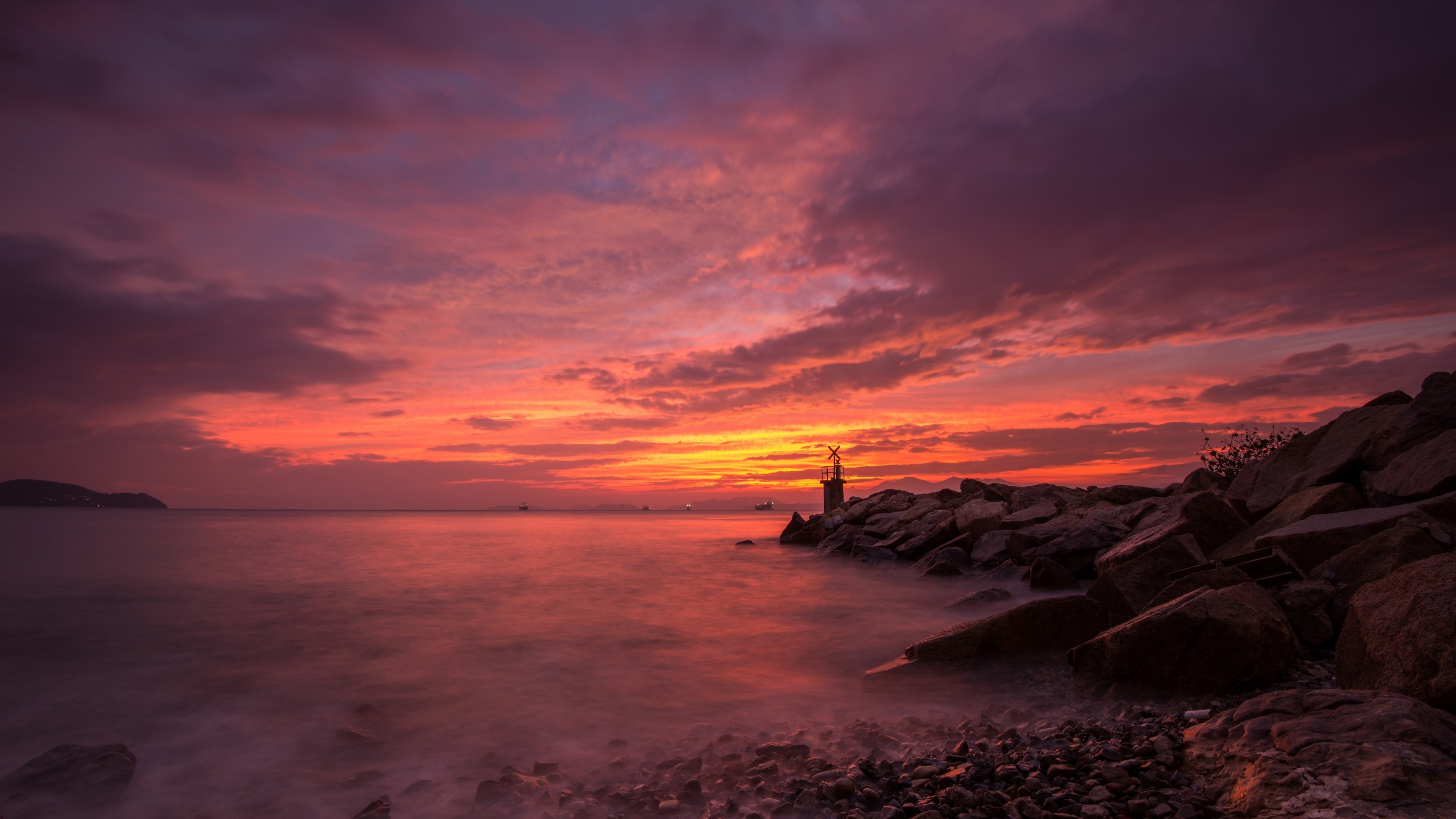 Sunset over the sea with a lighthouse HD Wallpaper