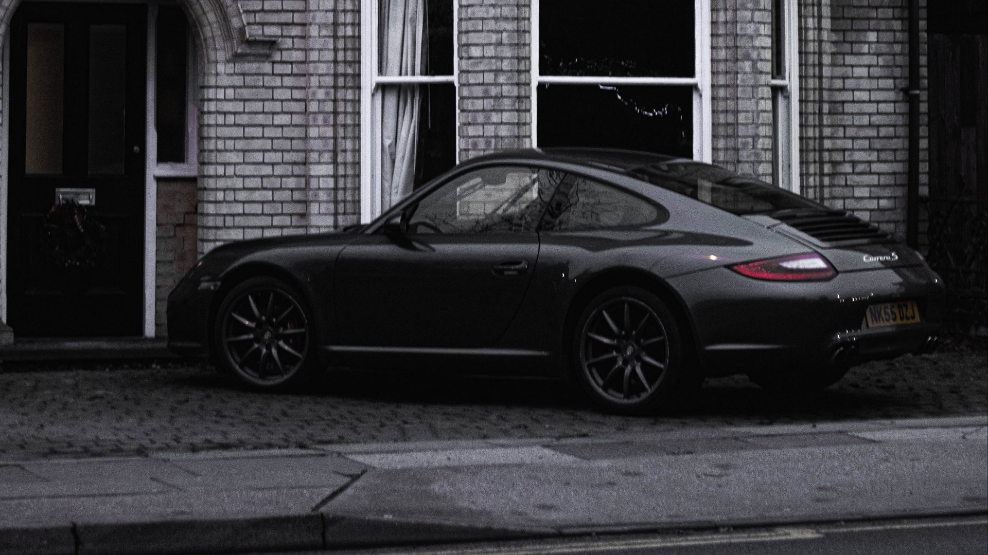 Porsche 911 Carrera S parked in front of a house HD Wallpaper