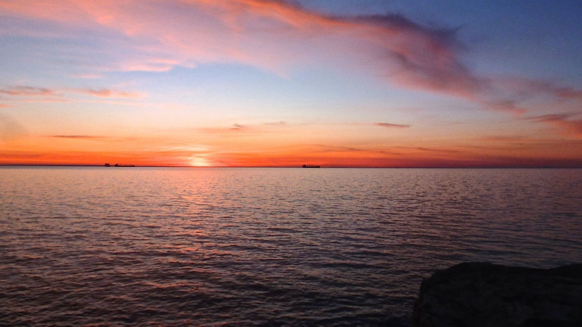 Sunset over the ocean with ships HD Wallpaper
