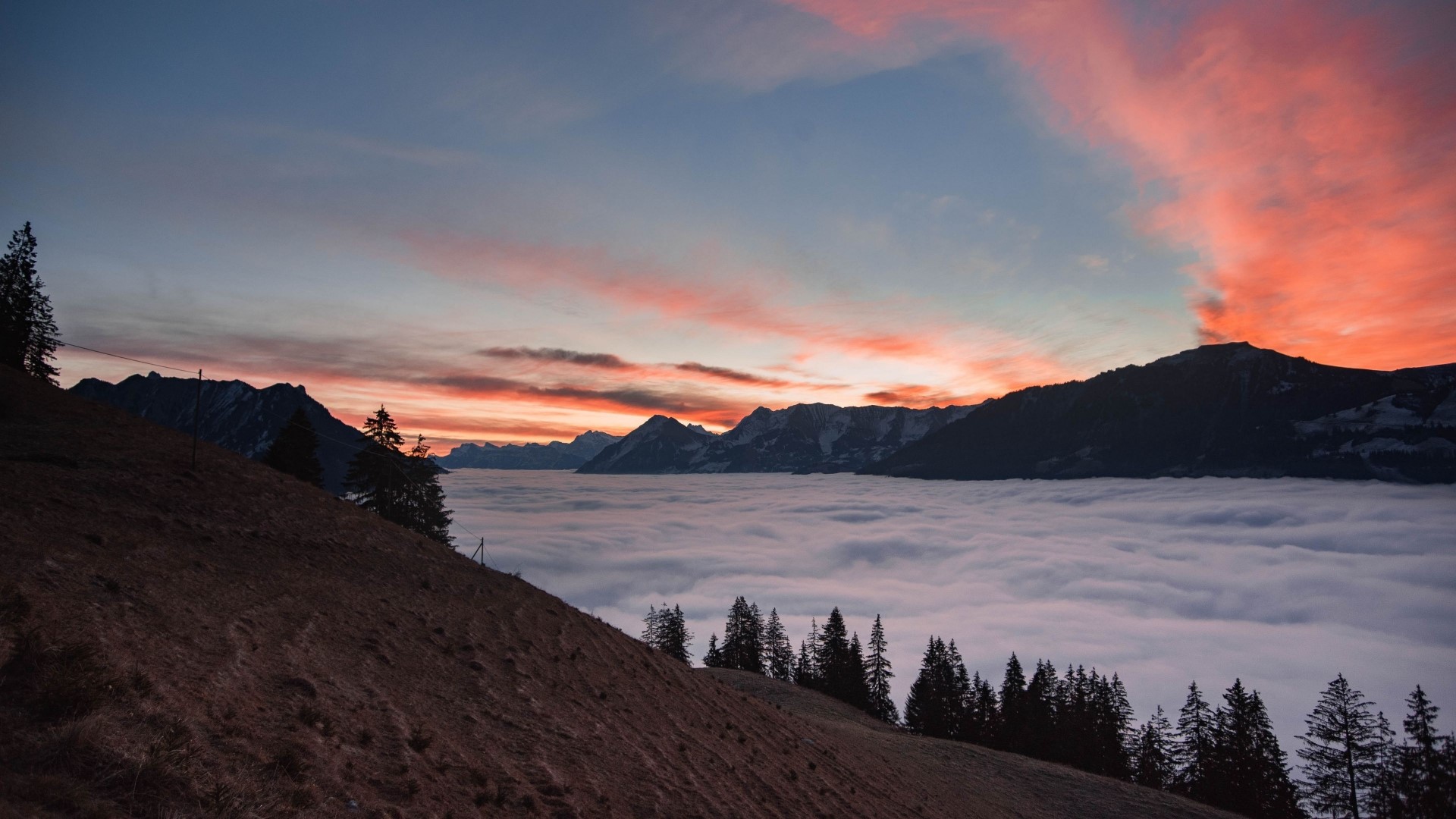 Mountain range above clouds at sunset HD Wallpaper