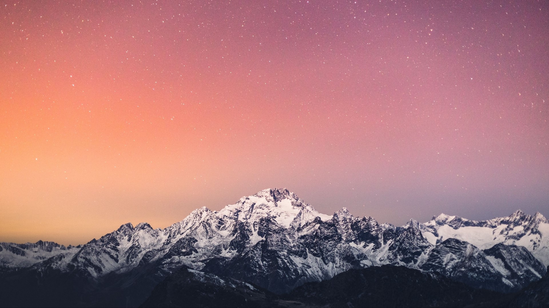 Snow-capped mountains under a starry sky HD Wallpaper
