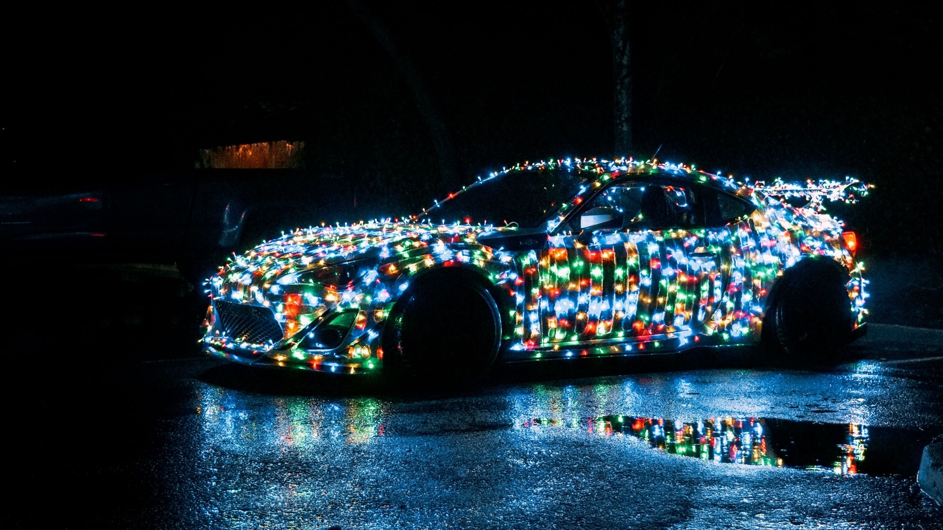 Car decorated with colorful Christmas lights at night HD Wallpaper