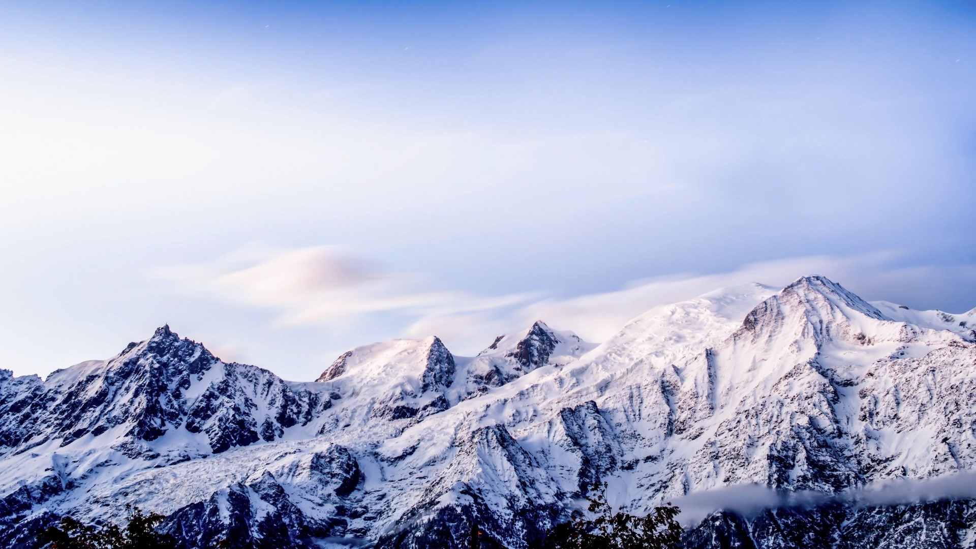 Snow-covered Alps mountains under a blue sky HD Wallpaper