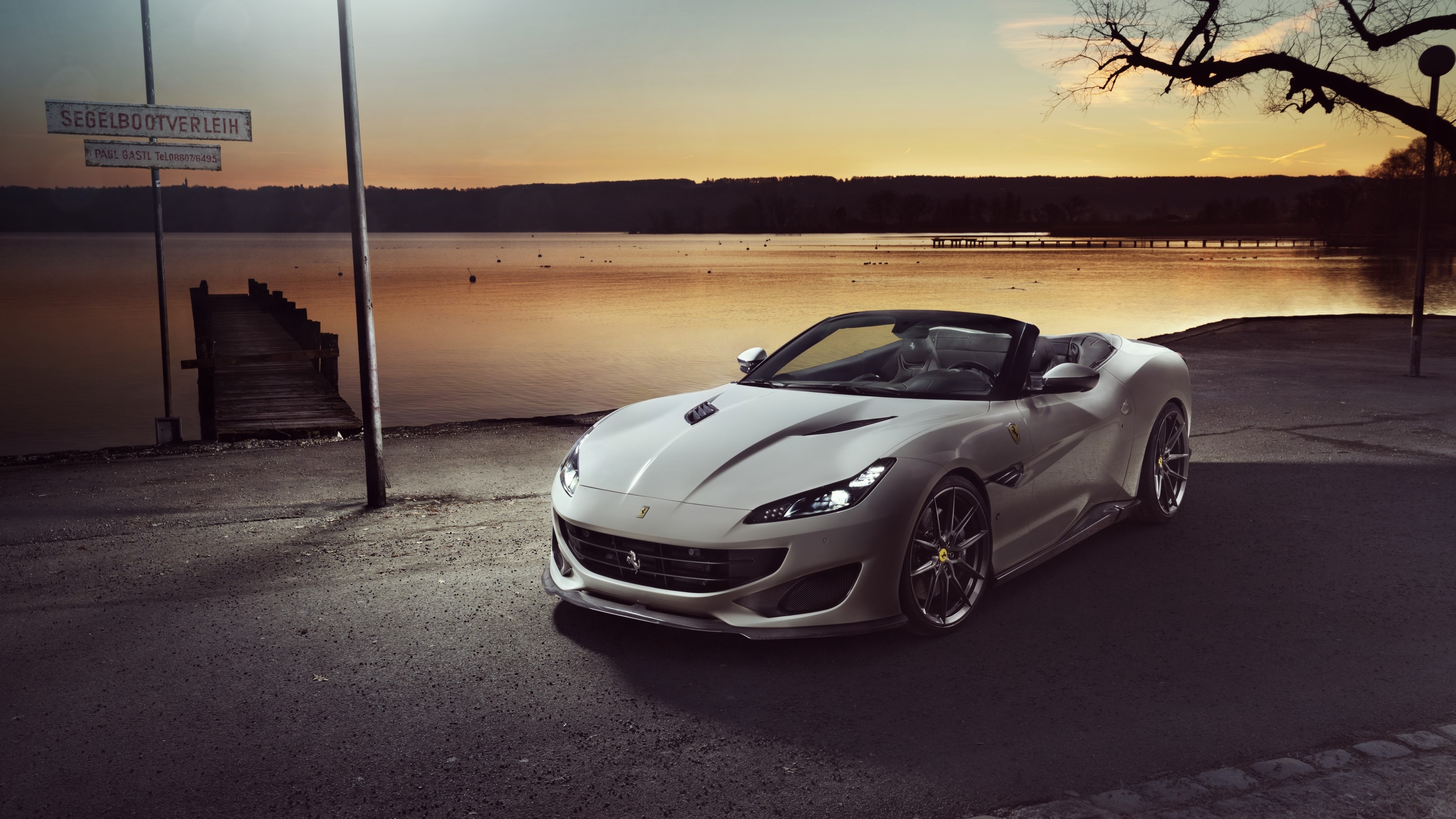 White convertible Ferrari parked by a lake at sunset HD Wallpaper