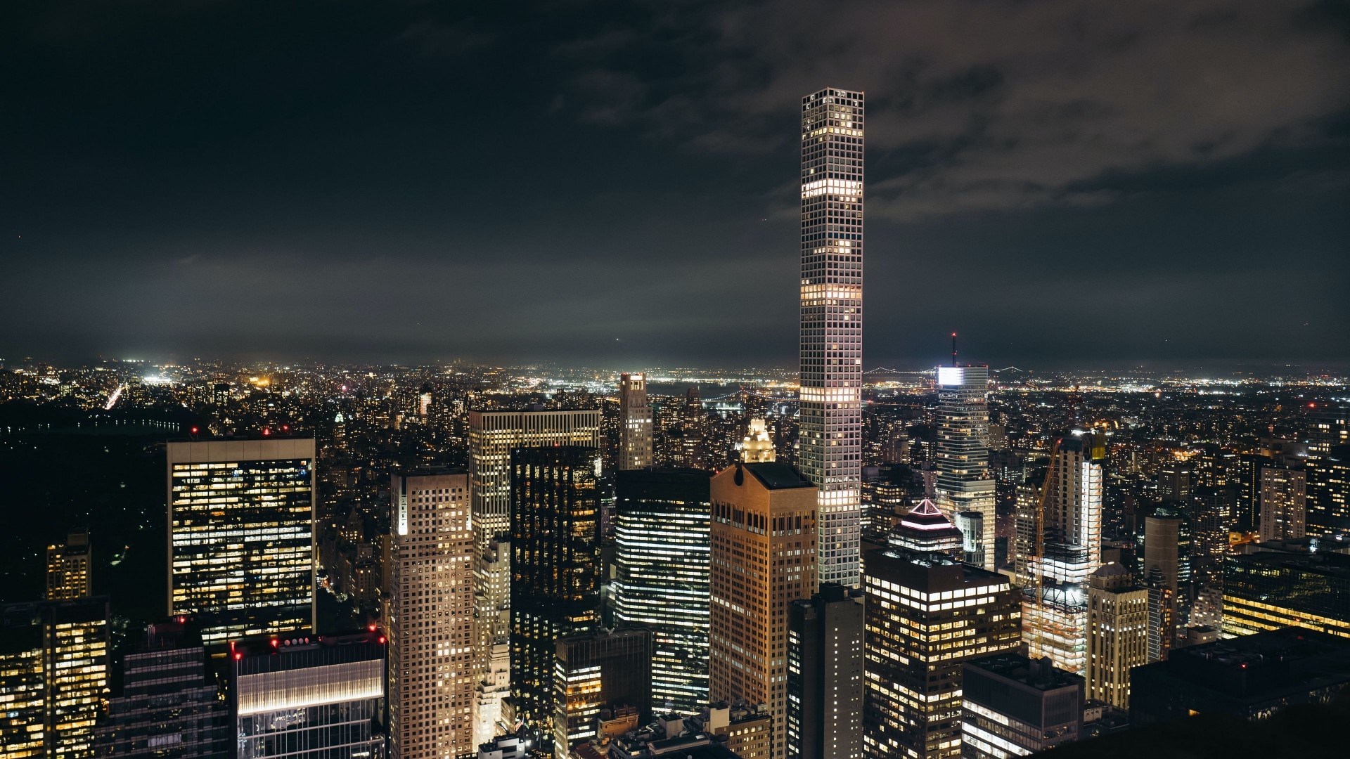Nighttime cityscape with illuminated skyscrapers HD Wallpaper