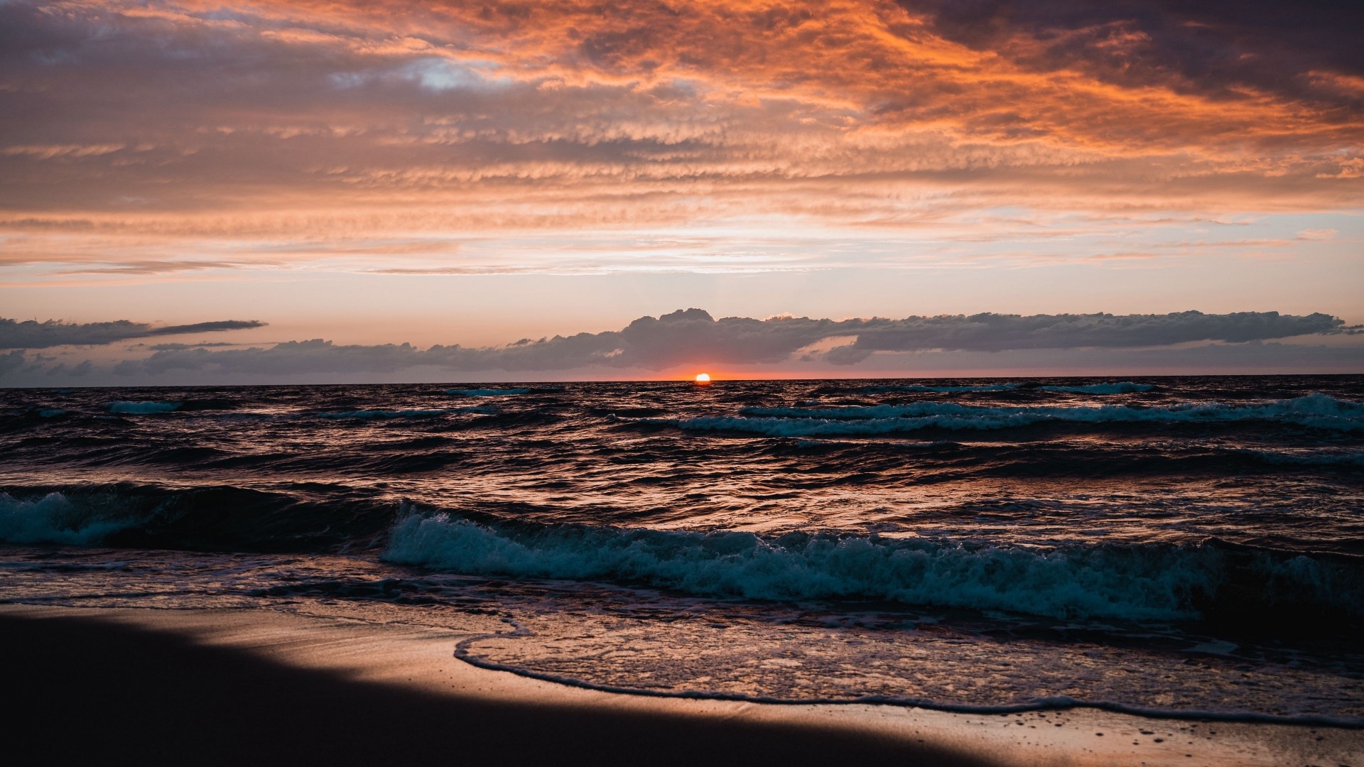 Sunset over the ocean with waves HD Wallpaper