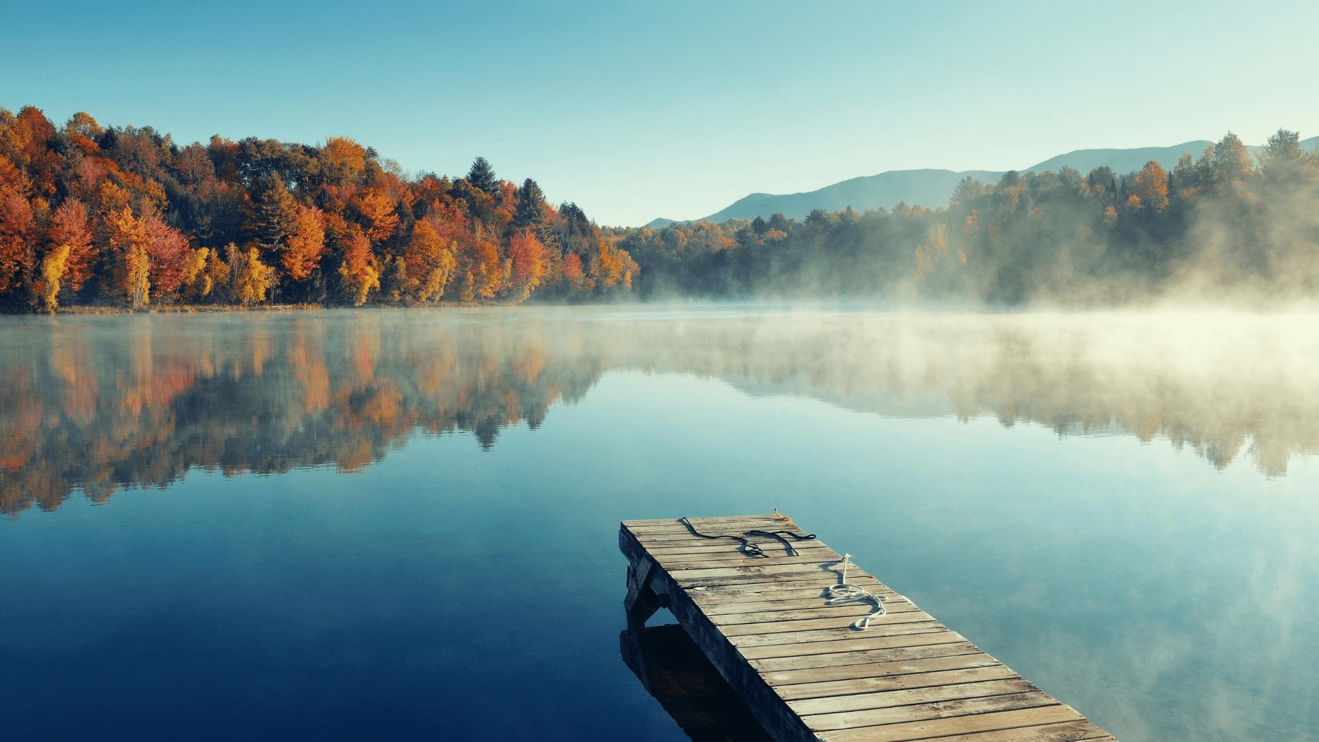 Autumn lake with wooden dock and misty forest HD Wallpaper