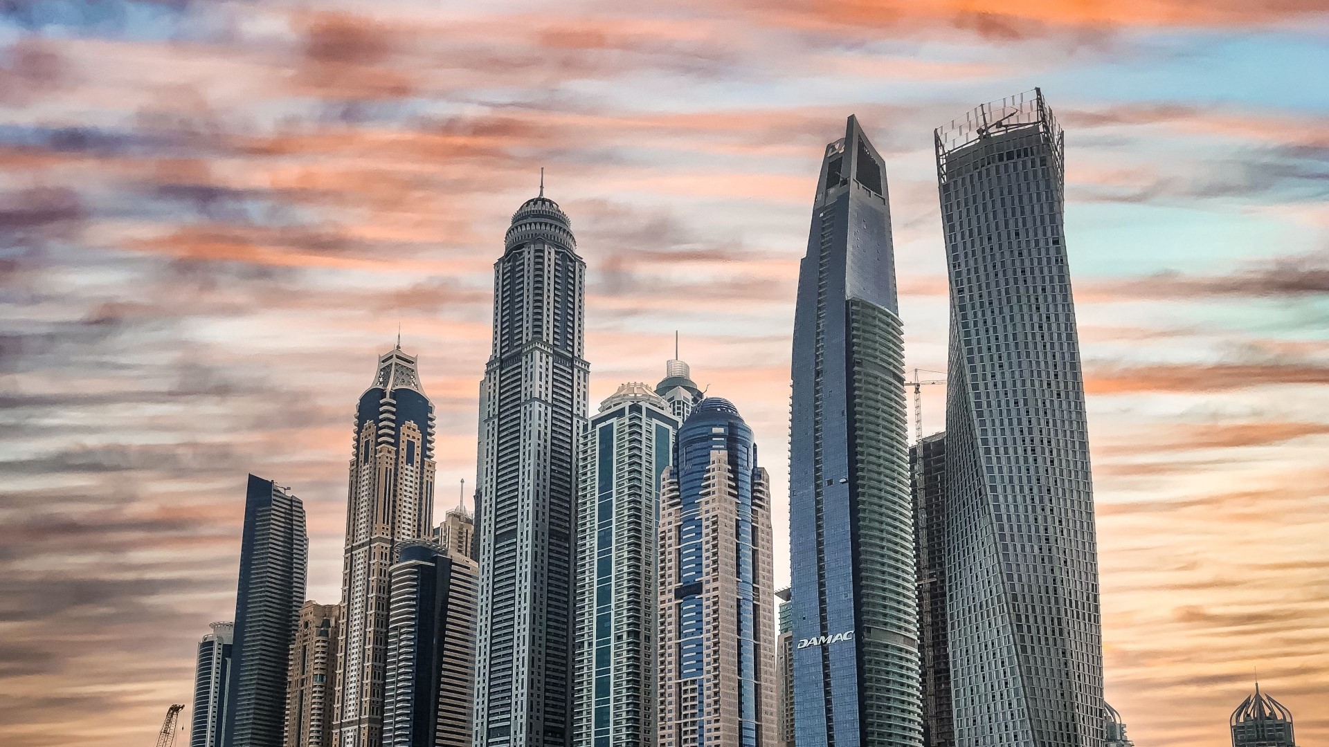 Dubai skyscrapers against a colorful sunset sky HD Wallpaper