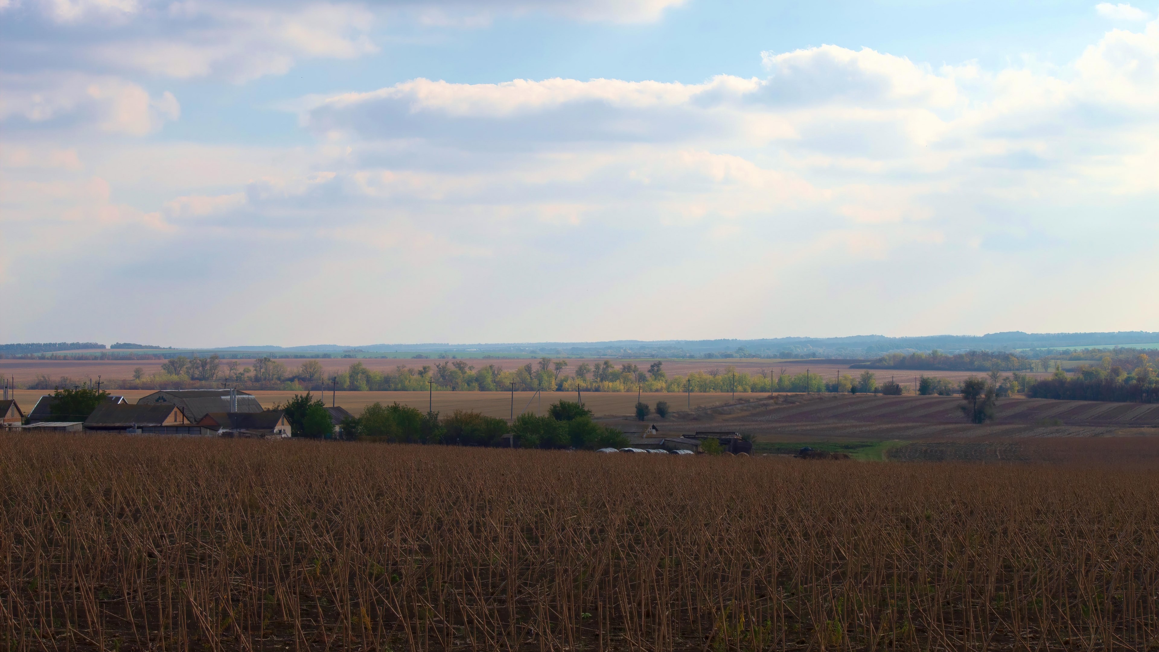 Autumn landscape with harvested fields and village HD Wallpaper