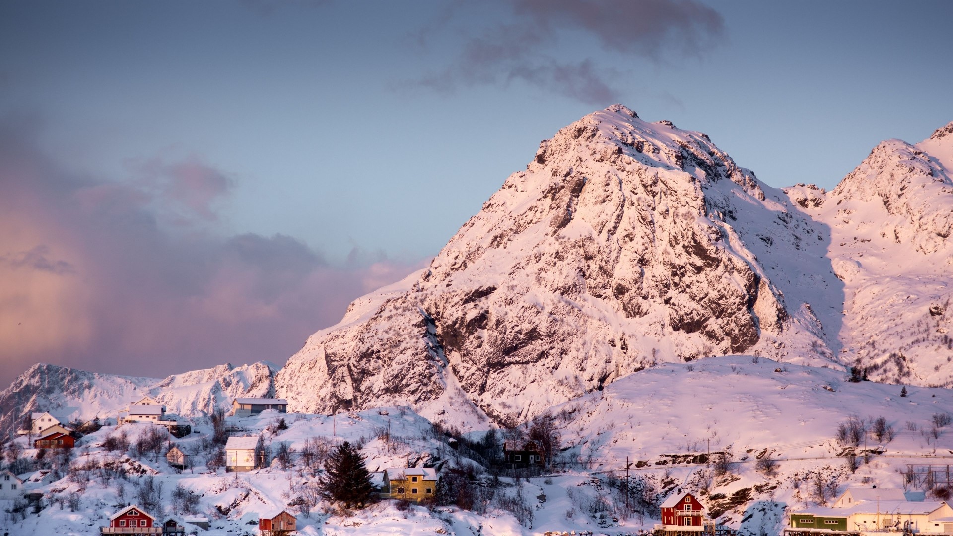 Snowy mountains with houses at sunset HD Wallpaper