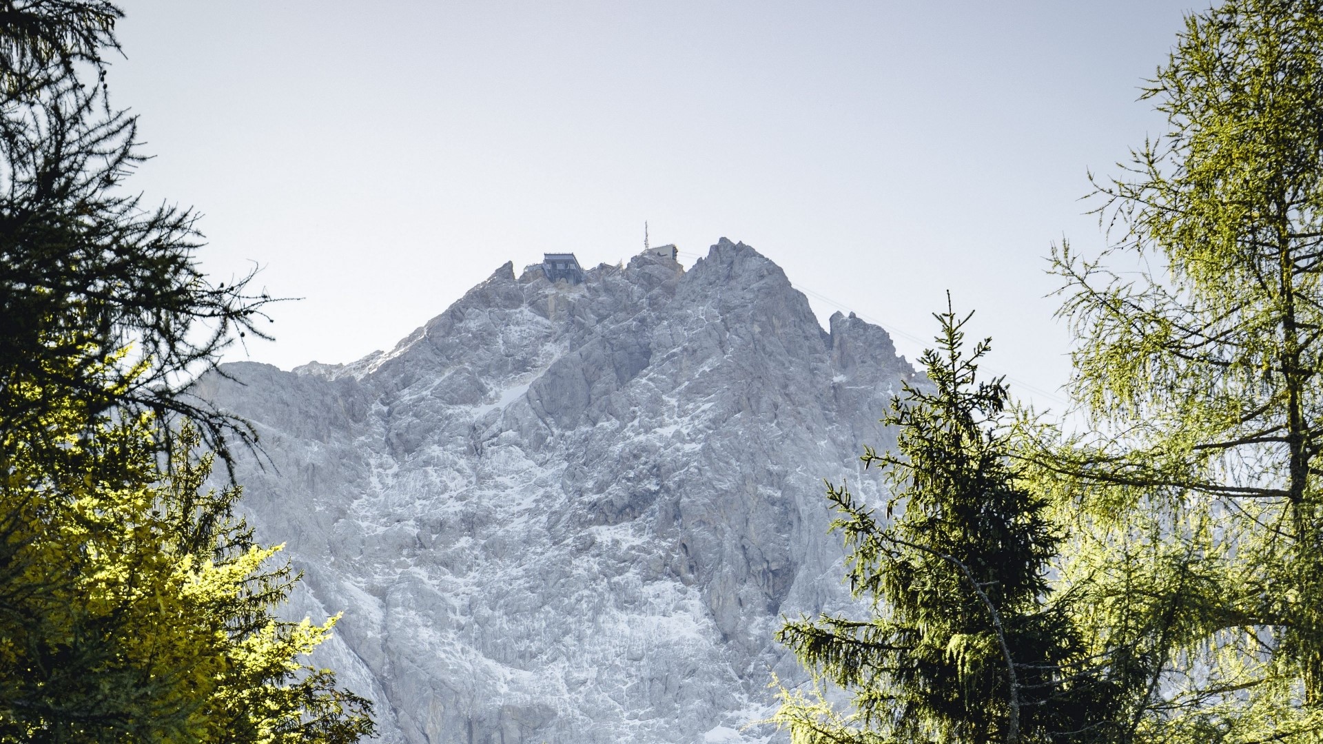 Mountain peak with buildings and trees HD Wallpaper