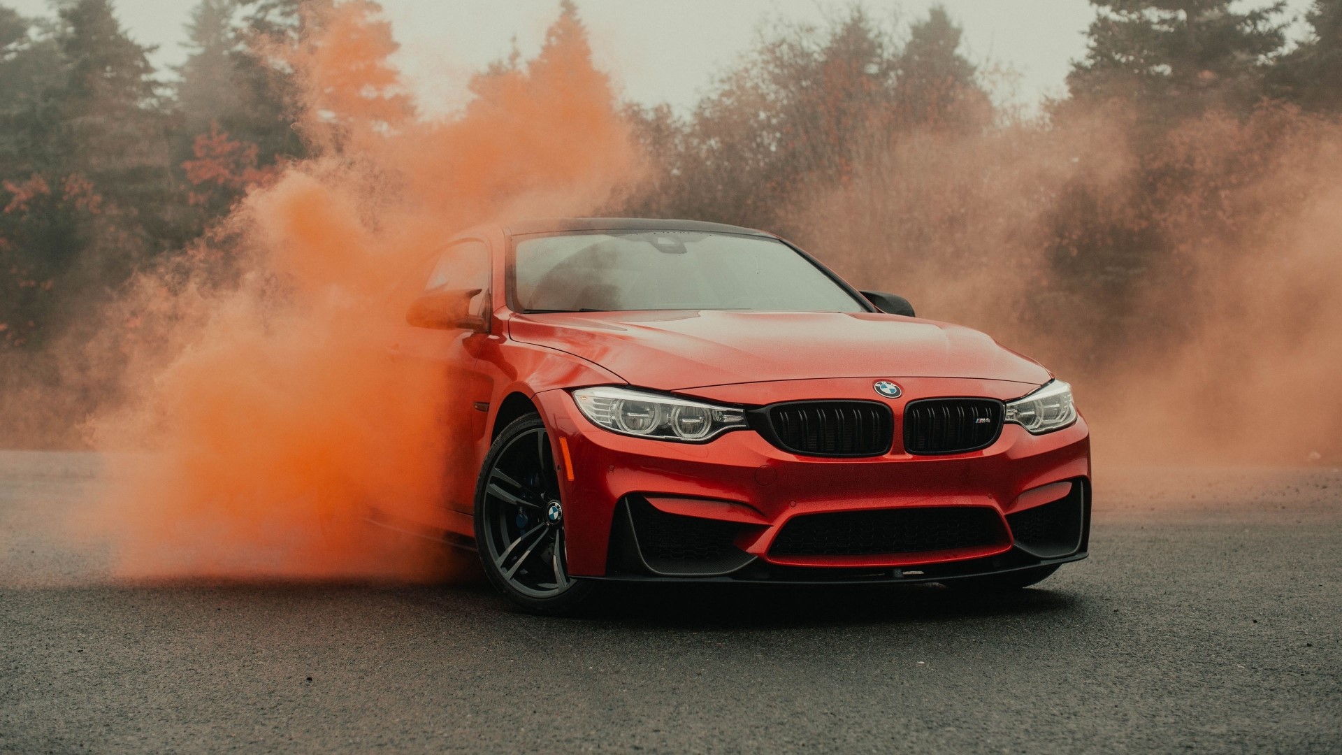 Red BMW M4 with orange smoke HD Wallpaper