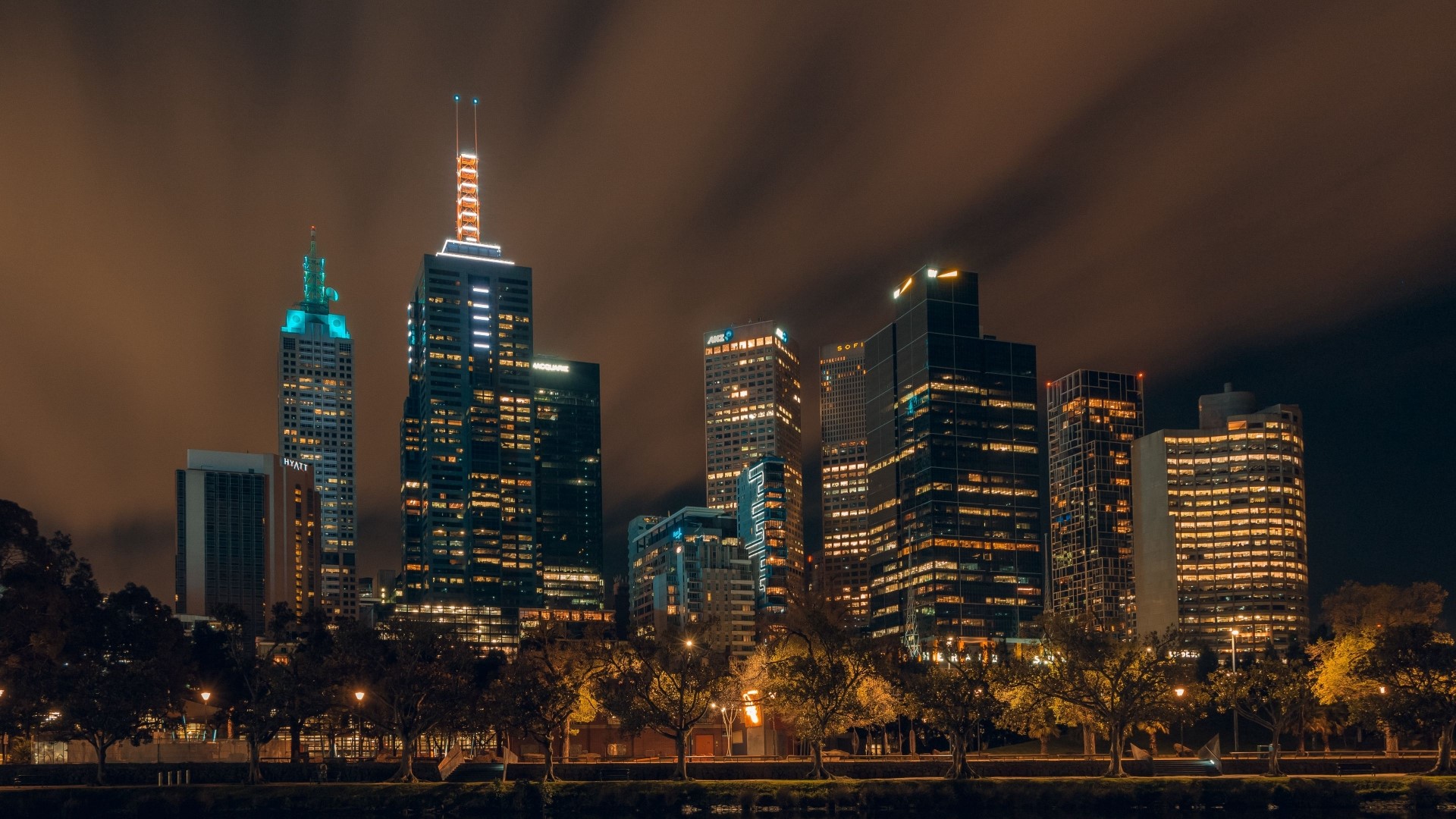 Night city skyline with illuminated skyscrapers HD Wallpaper
